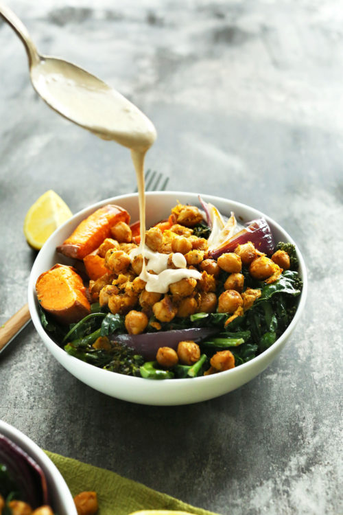 Drizzling tahini sauce over a Sweet Potato Chickpea Buddha Bowl