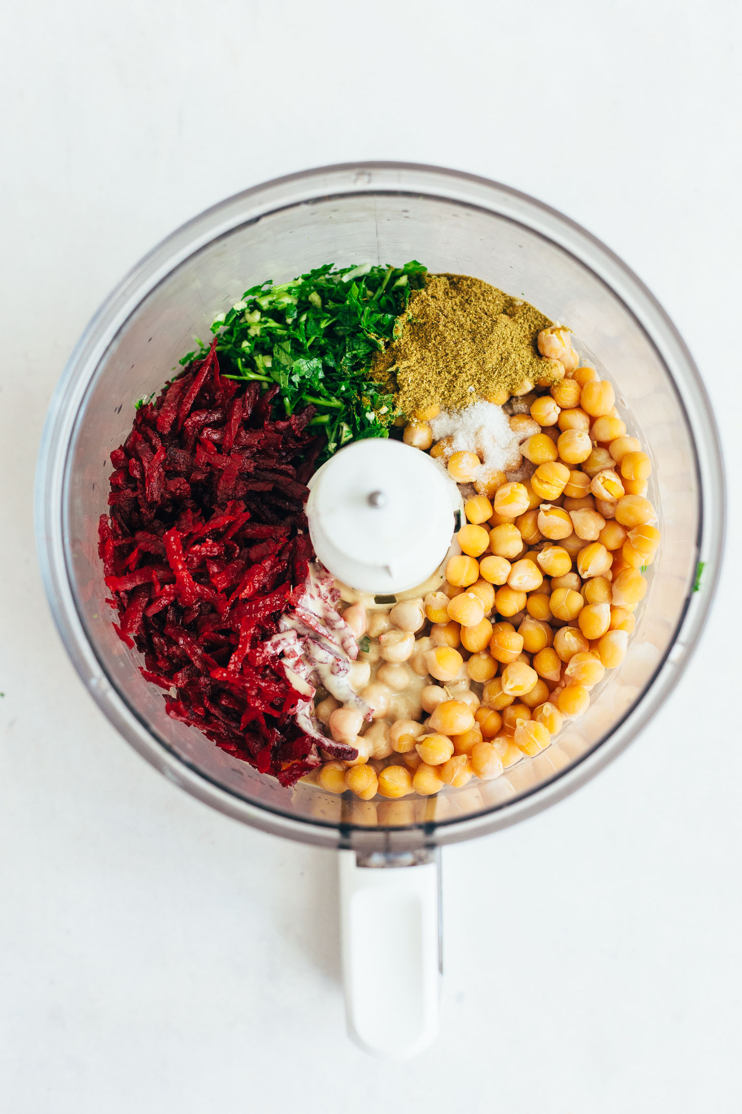 Blender with beets, parsley, cumin, salt, chickpeas, and tahini