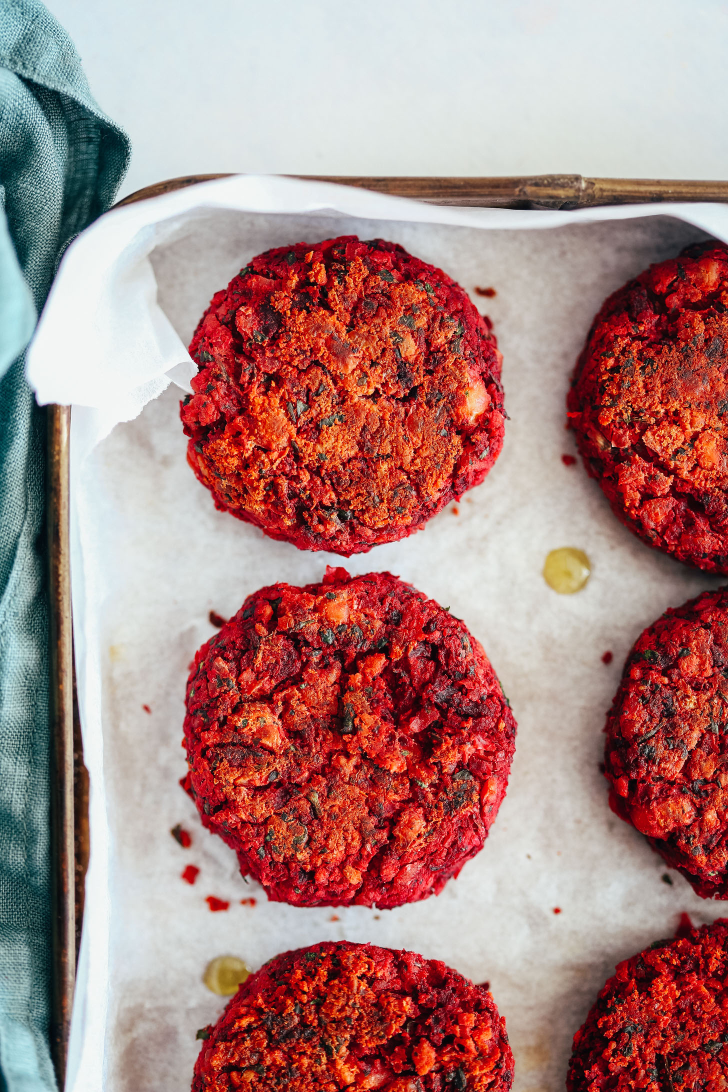 Parchment-lined baking sheet of beet falafel patties