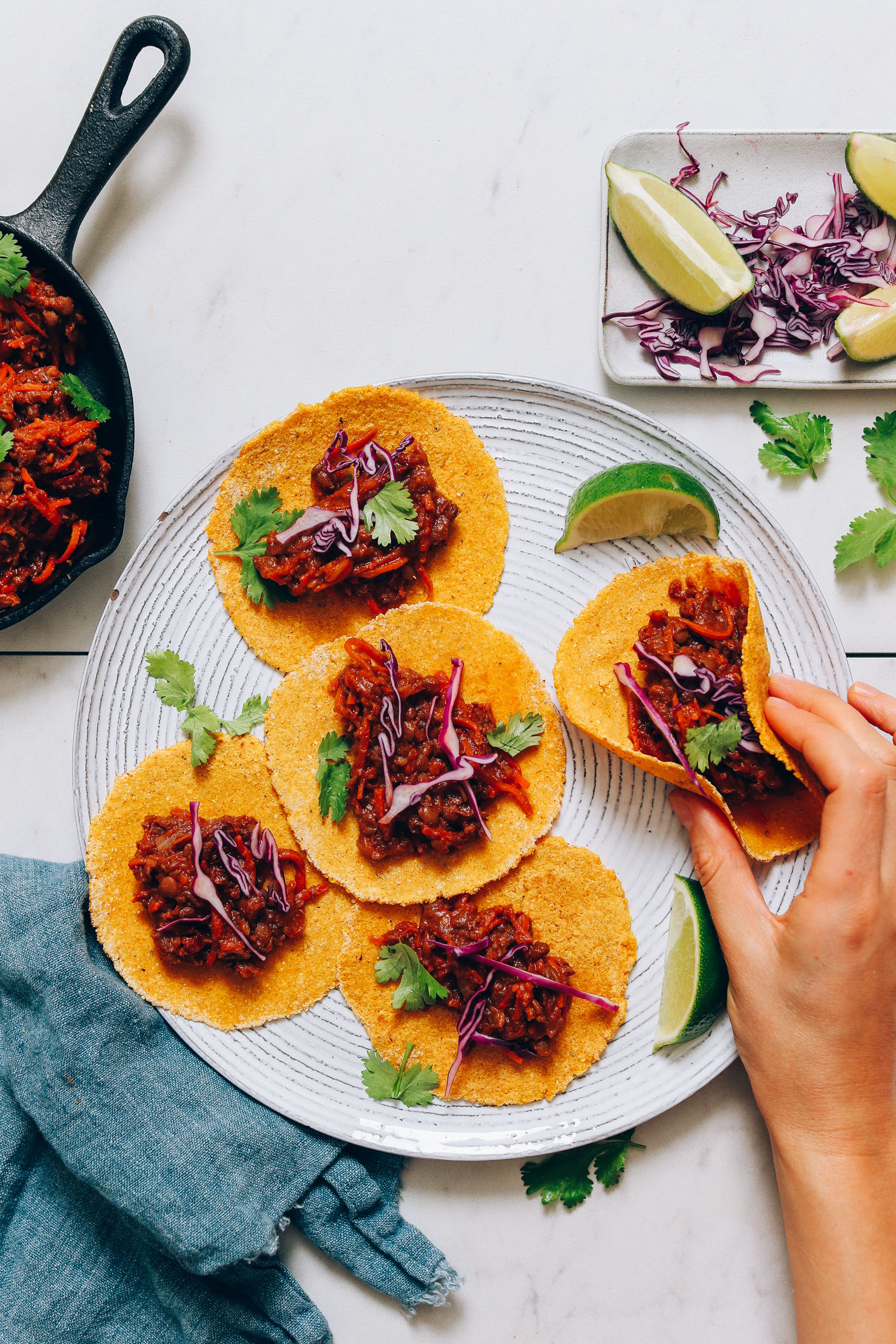Picking up a vegan taco filled with spiced carrots and lentils