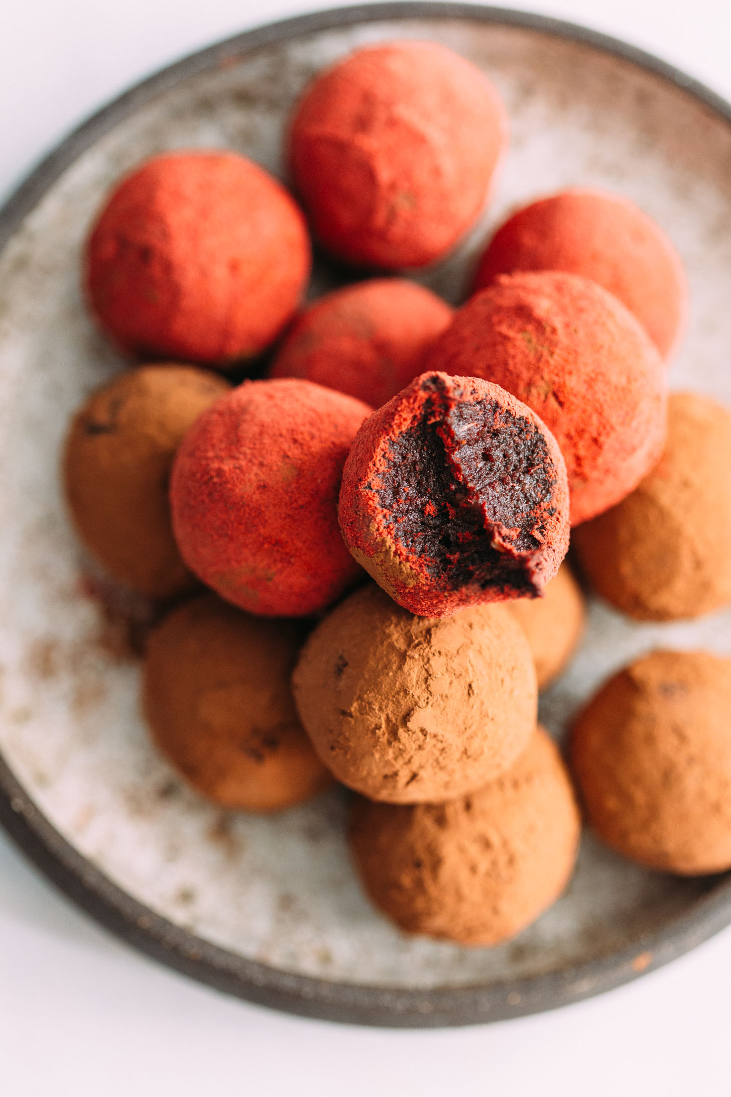 Pile of red velvet cake balls on a plate