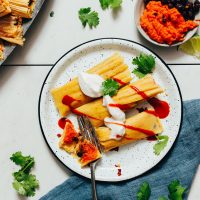 Fork cutting into a bite of Sweet Potato Black Bean Tamales