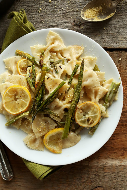 Plate of Creamy Vegan Lemon Asparagus Pasta on a wood background