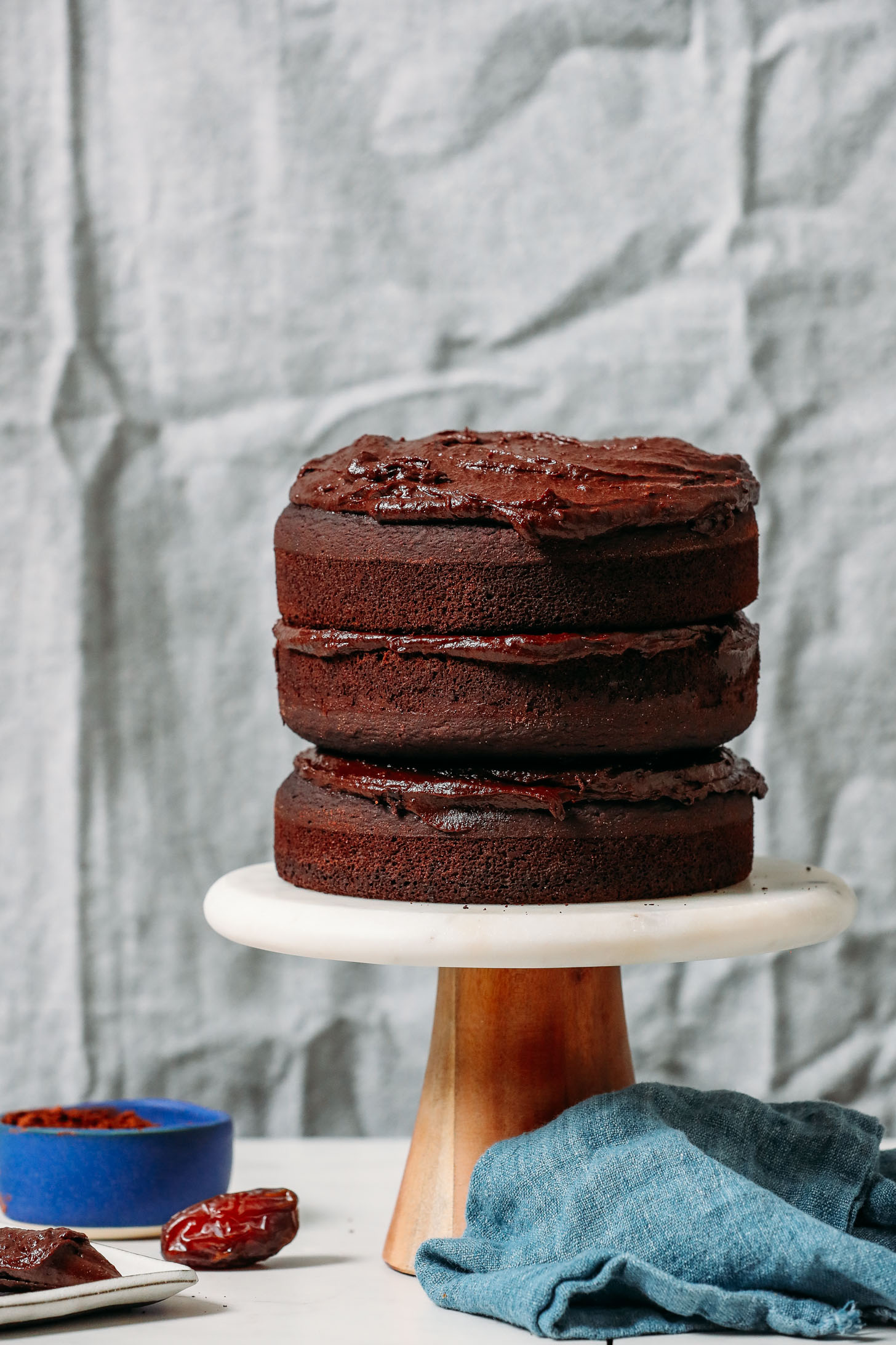 Three tier Gluten Free Chocolate Cake topped with Vegan Chocolate Frosting
