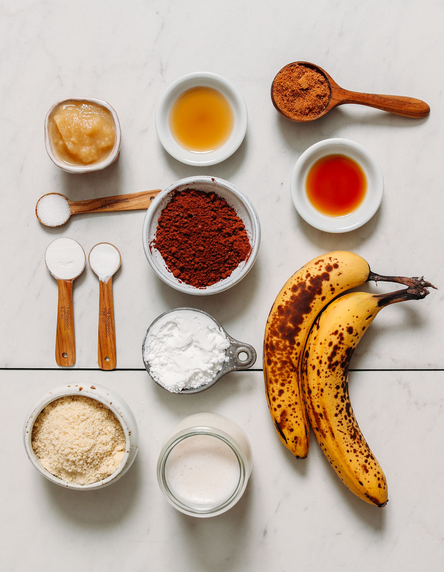 Applesauce, maple syrup, coconut sugar, cocoa powder, bananas, gluten free flours, baking soda, baking powder, salt, and dairy-free milk