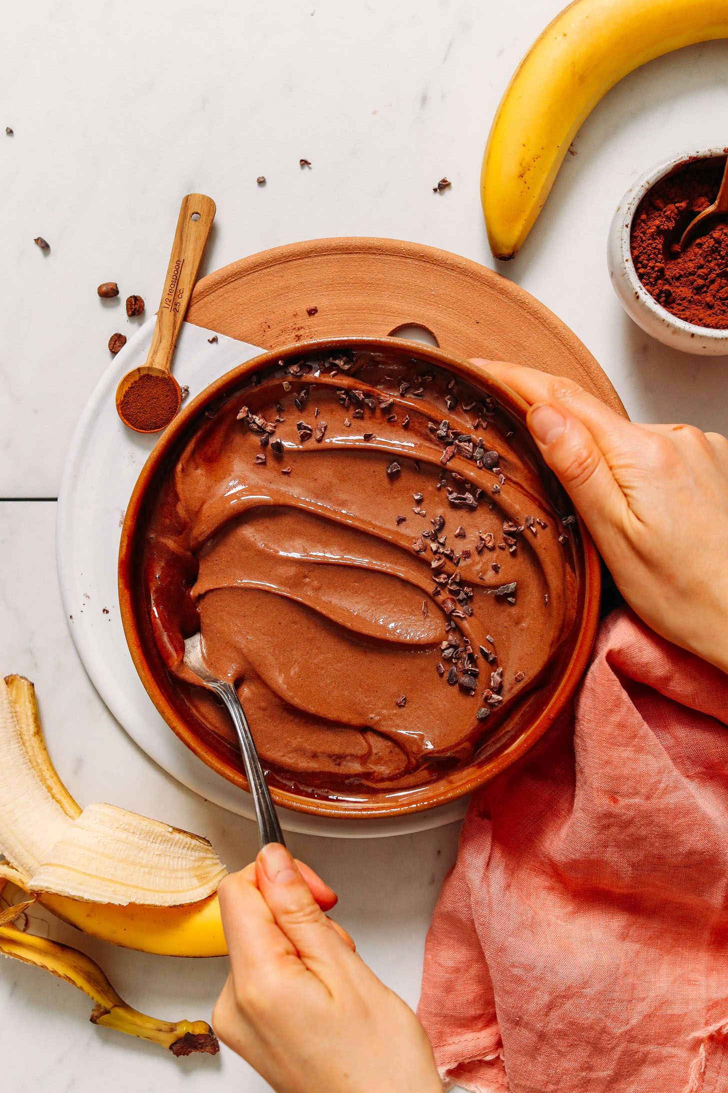 Scooping up a spoonful of Chocolate Nice Cream from a bowl