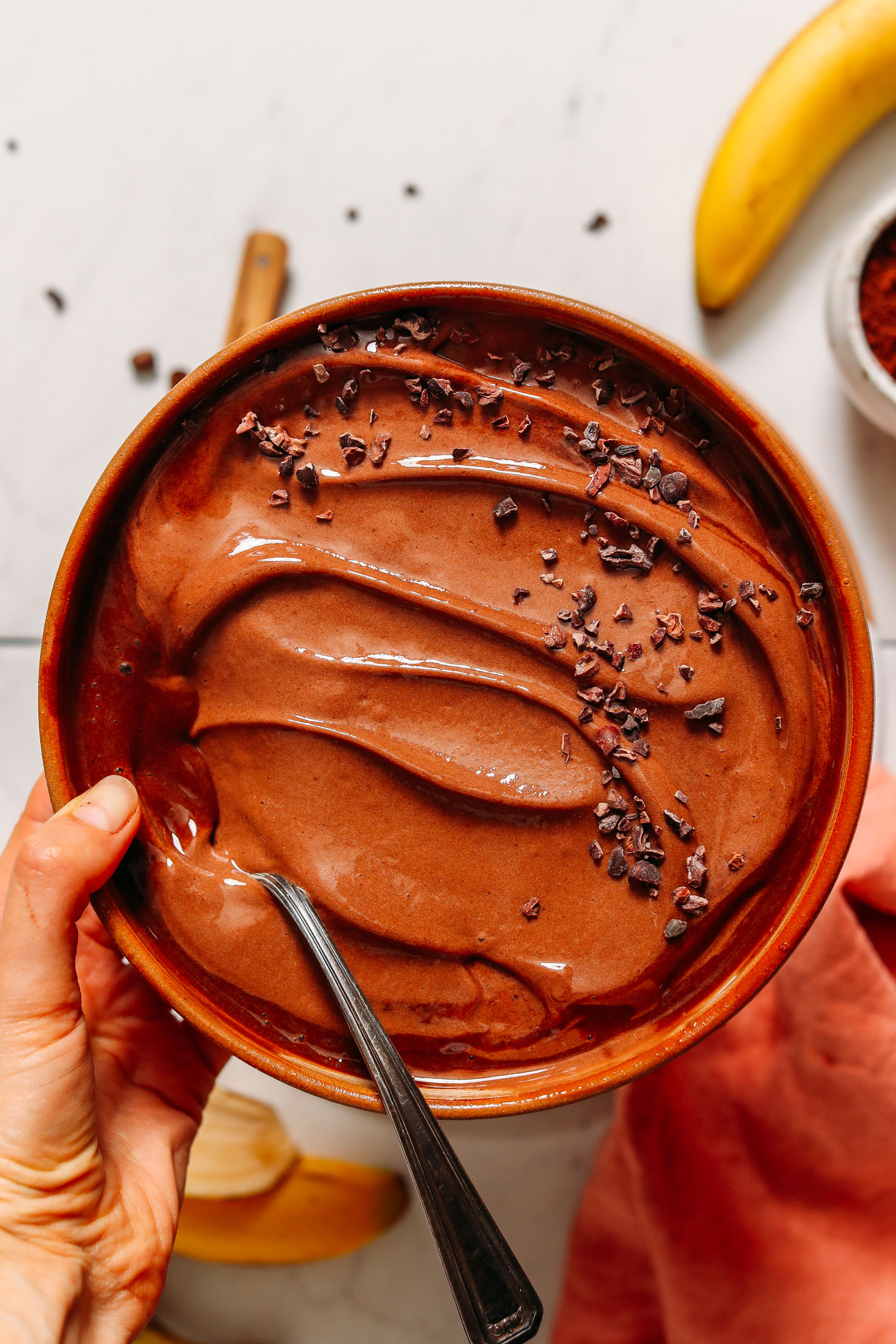 Holding a bowl of Coffee Chocolate Nice Cream topped with cacao nibs