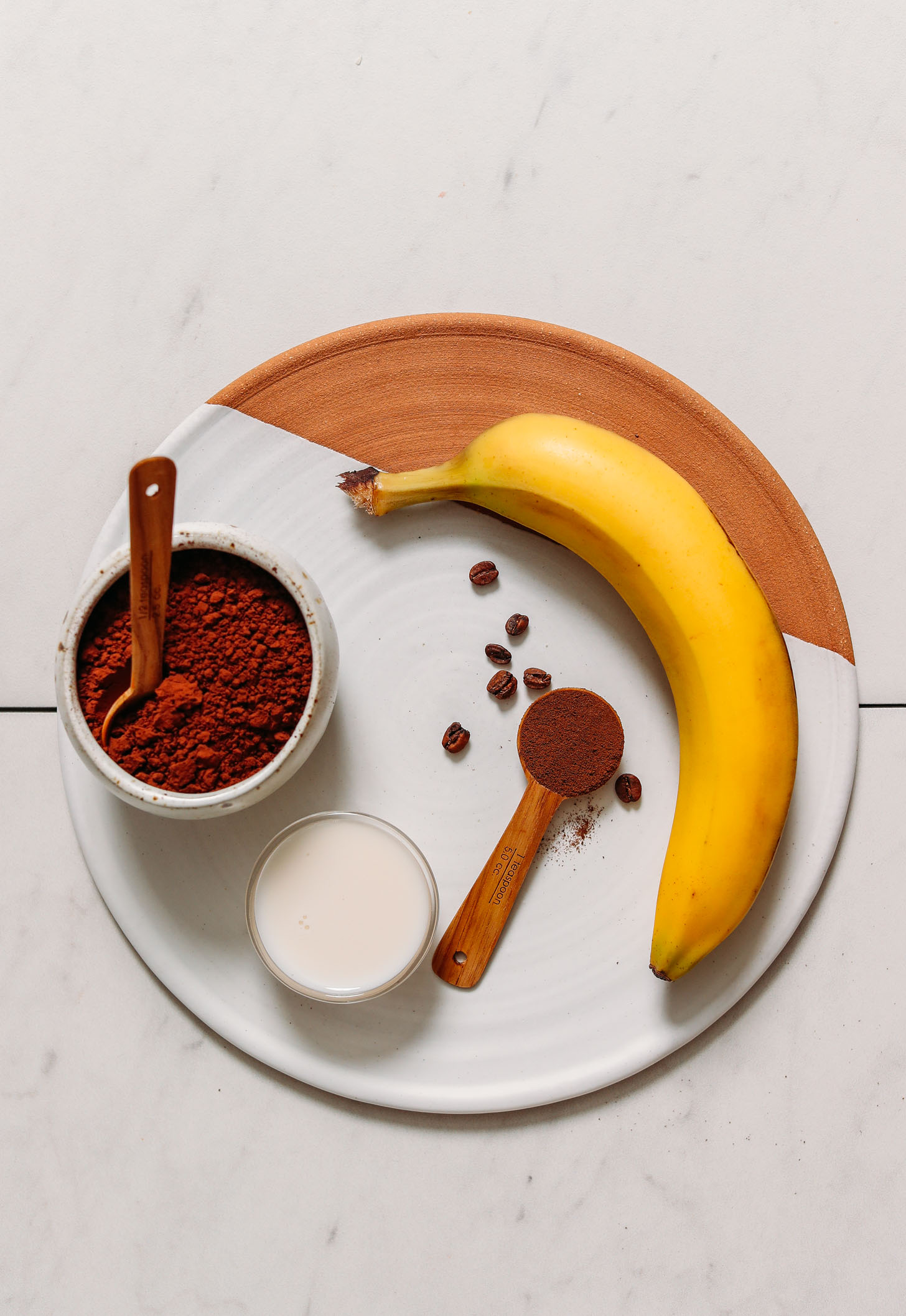 Tray with banana, coffee beans, dandy blend, cacao powder, and dairy-free milk