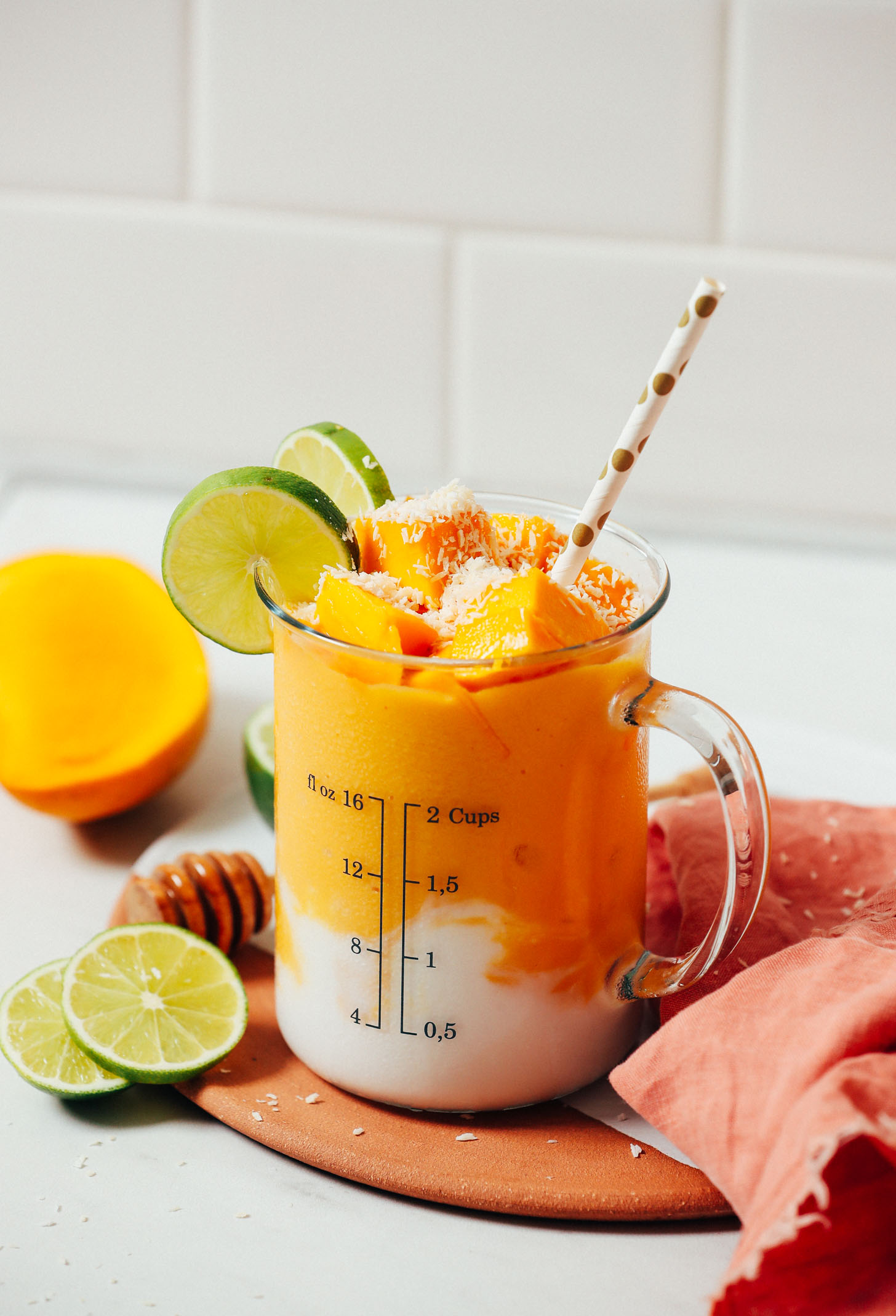 Coconut milk swirled at the bottom of a glass filled with our dairy-free Mango Lassi recipe