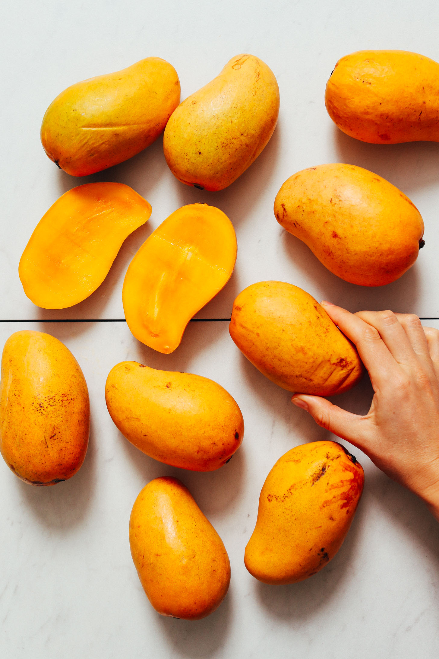 Halved and whole mangoes