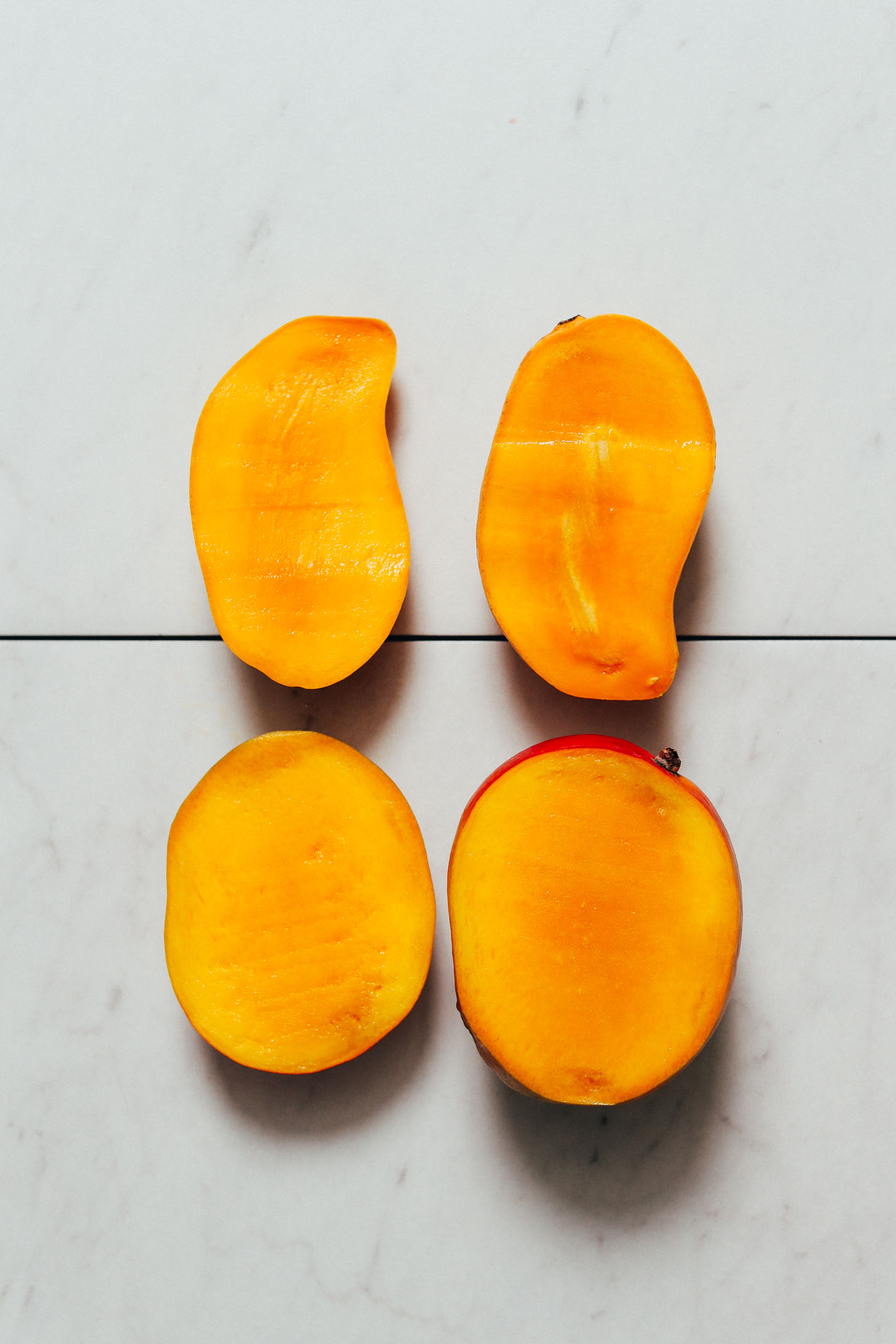 Two halved mangoes