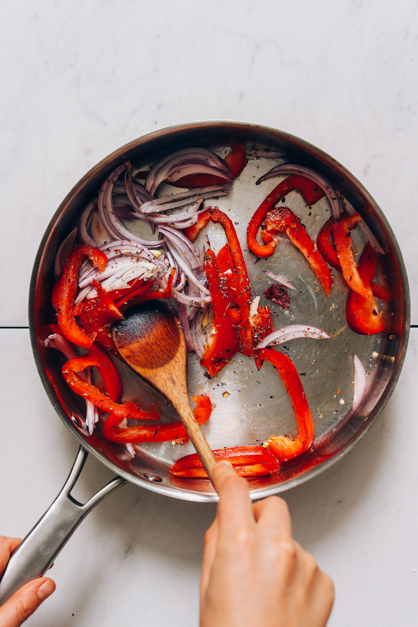 Sautéing red onion and bell pepper with oregano