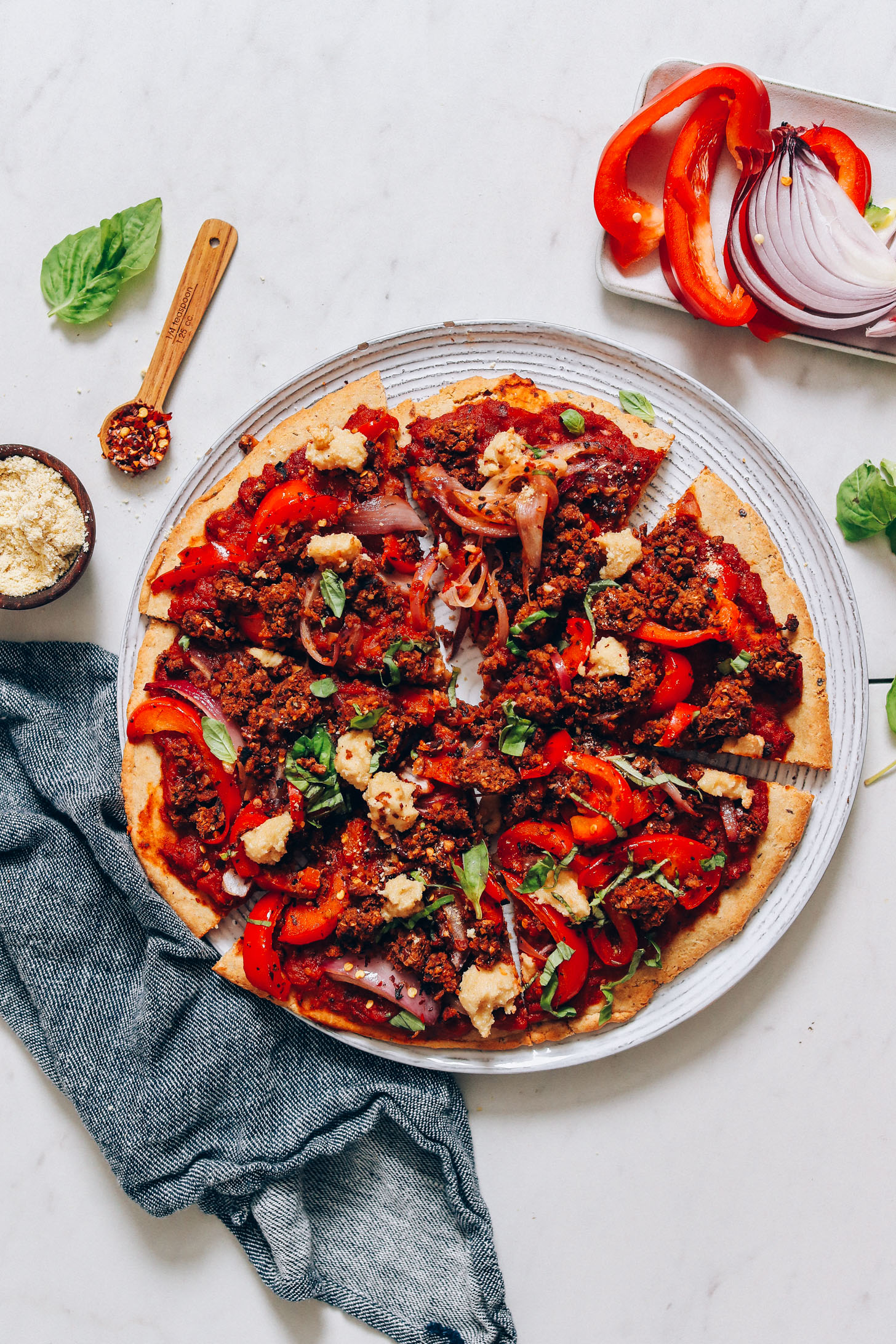 Plate of sliced Veggie & Sausage Vegan Pizza