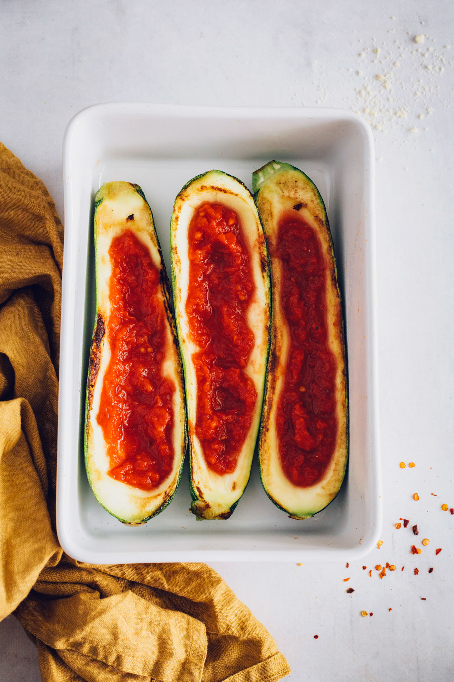 Baking pan of zucchini boats with marinara