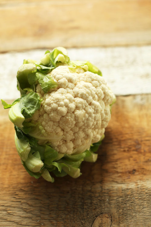Head of cauliflower on a wood cutting board