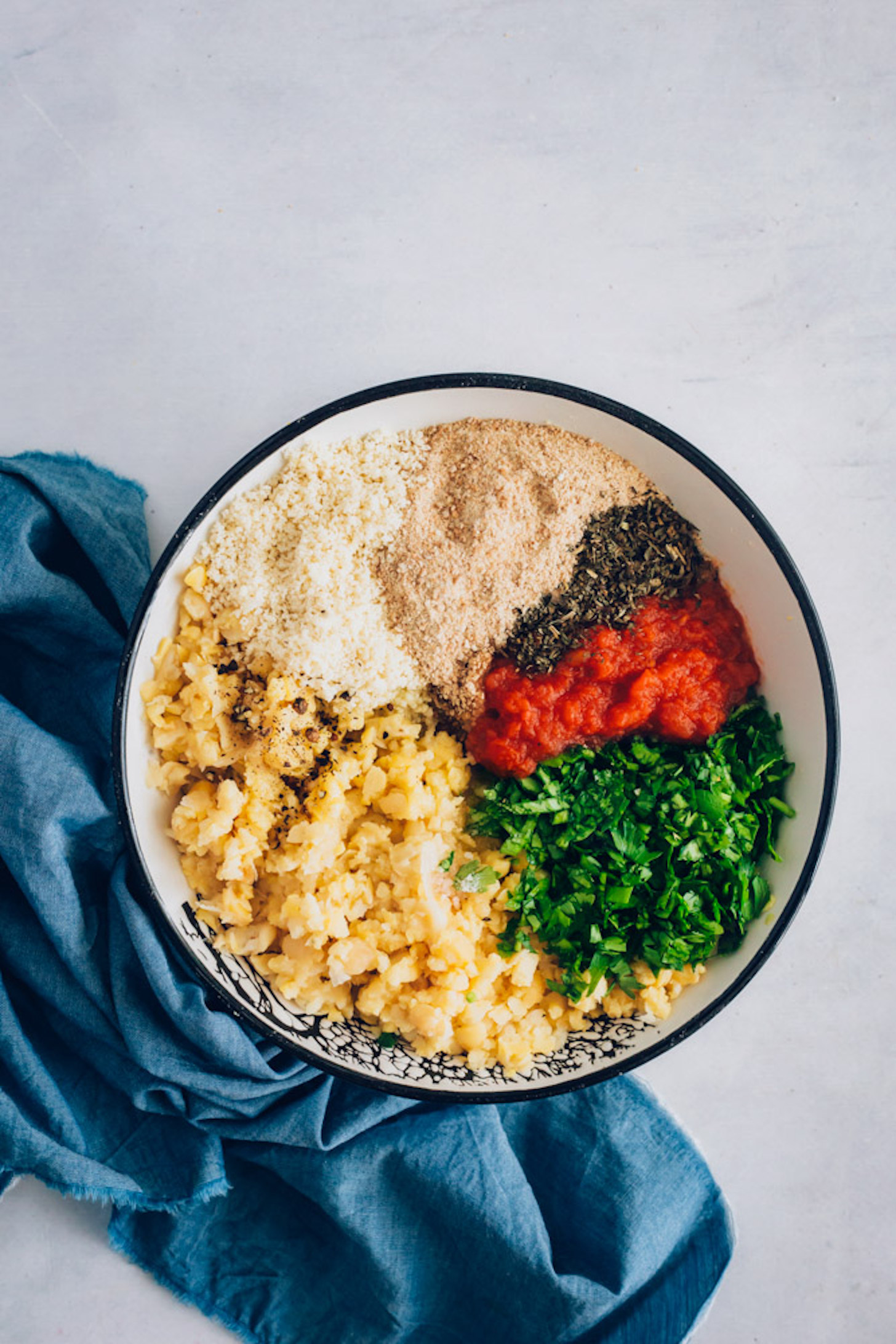 Bowl of mashed chickpeas, spices, marinara, and breadcrumbs
