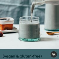Pouring a glass of vegan black sesame milk