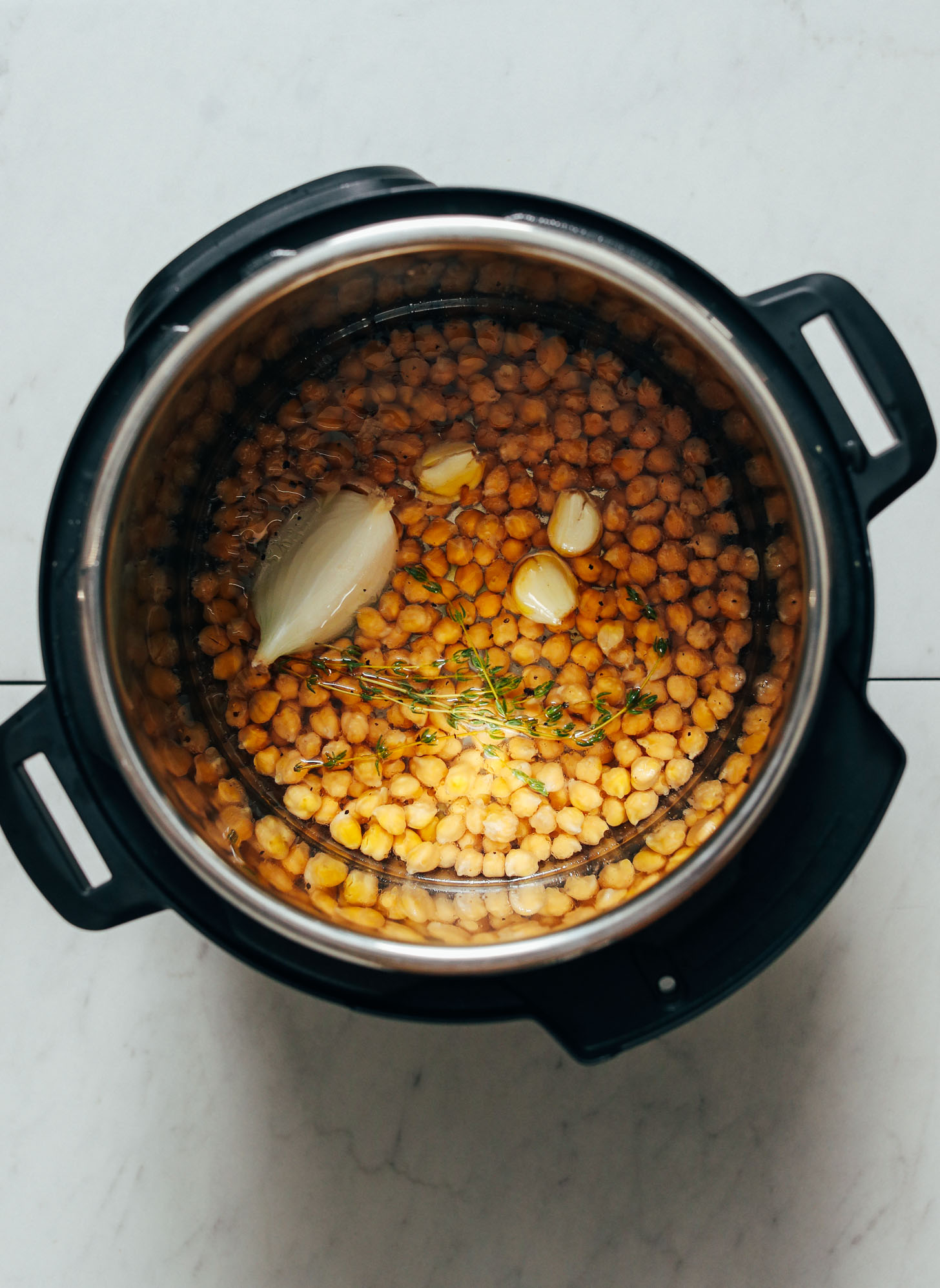 Instant pot with chickpeas, onion, garlic, and thyme