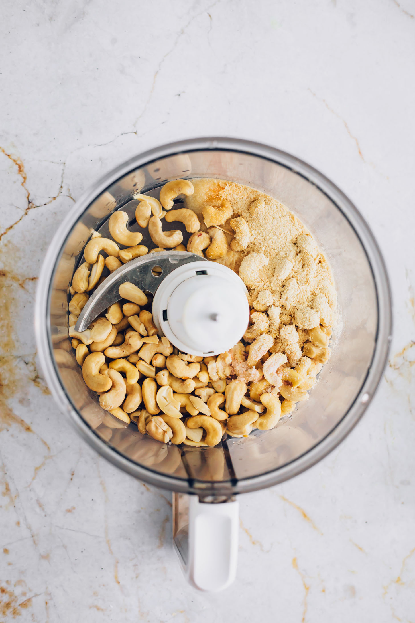 Cashews and nutritional yeast in a food processor
