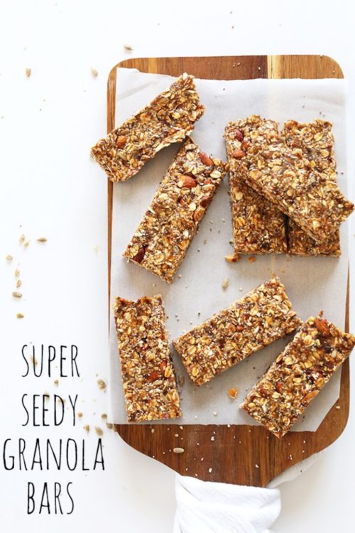 Parchment-lined cutting board of Super Seedy Granola Bars