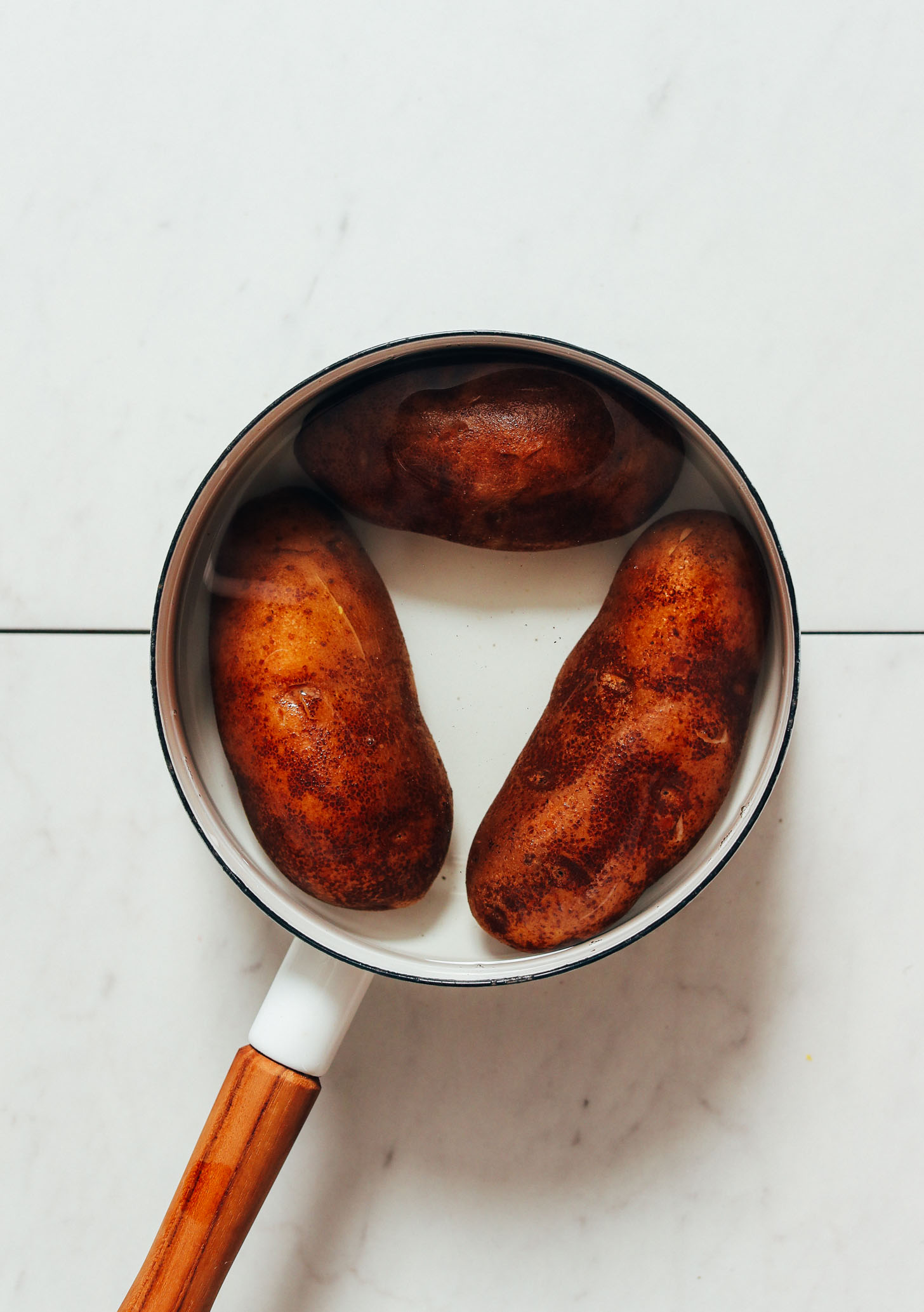 Saucepan of russet potatoes in water