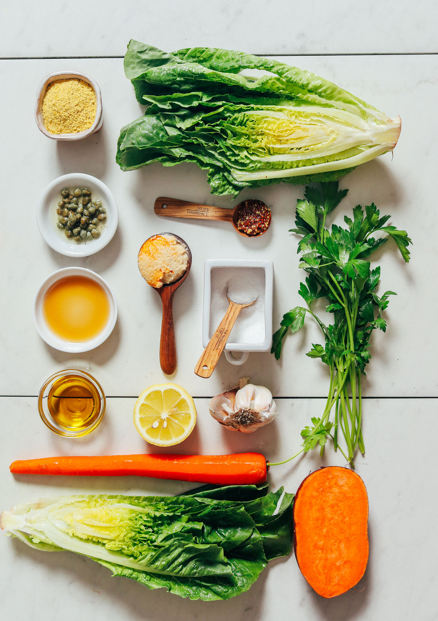 Romaine, nutritional yeast, capers, carrots, sweet potato, garlic, hummus, lemon, olive oil, and seasonings