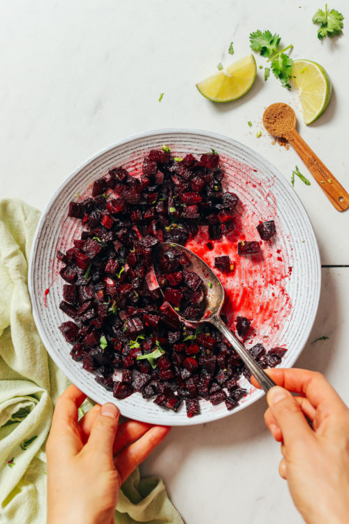 Vintage spoon in a bowl of Roasted Beet Relish topped with cilantro