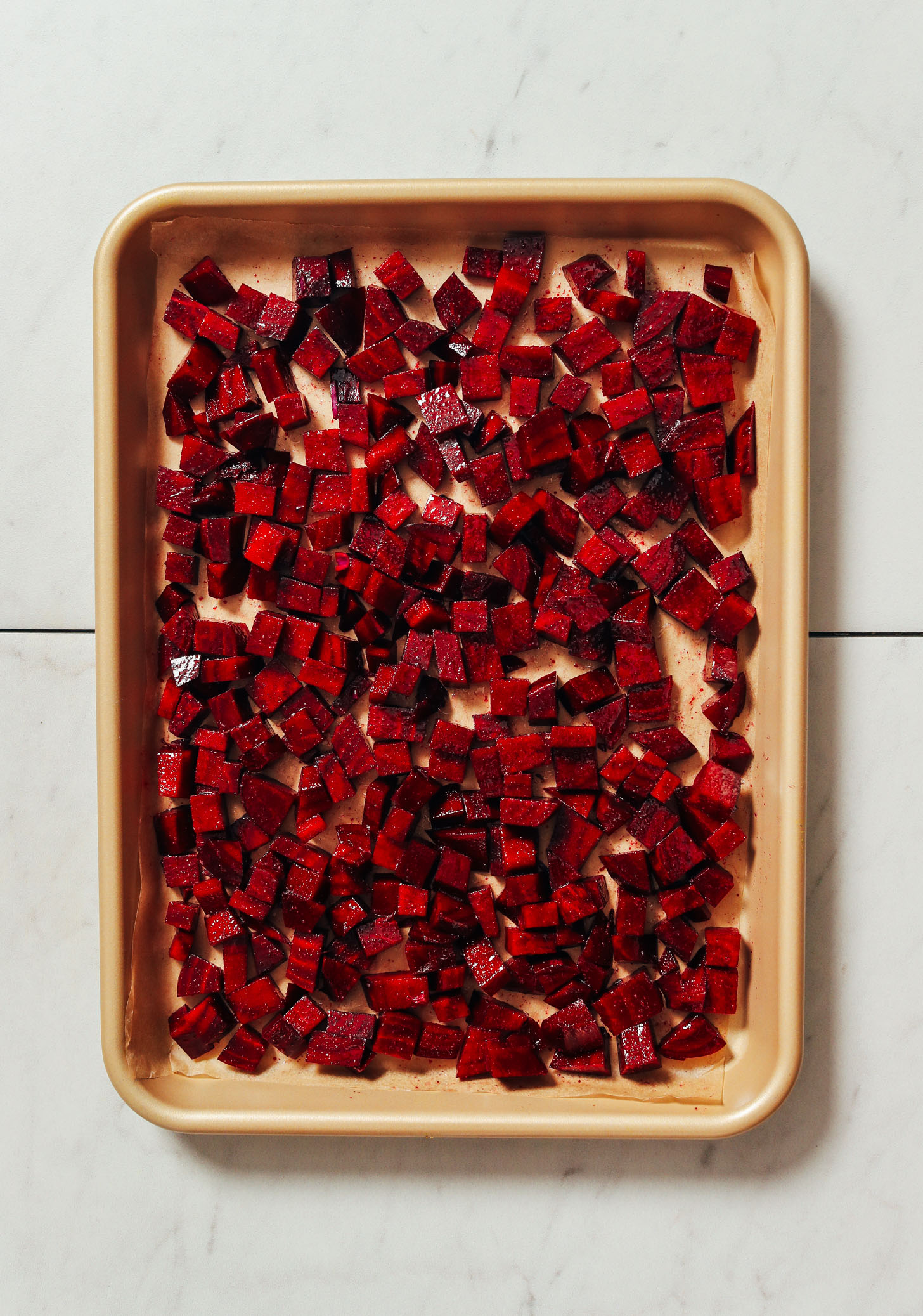 Baking sheet of cubed beets with seasonings