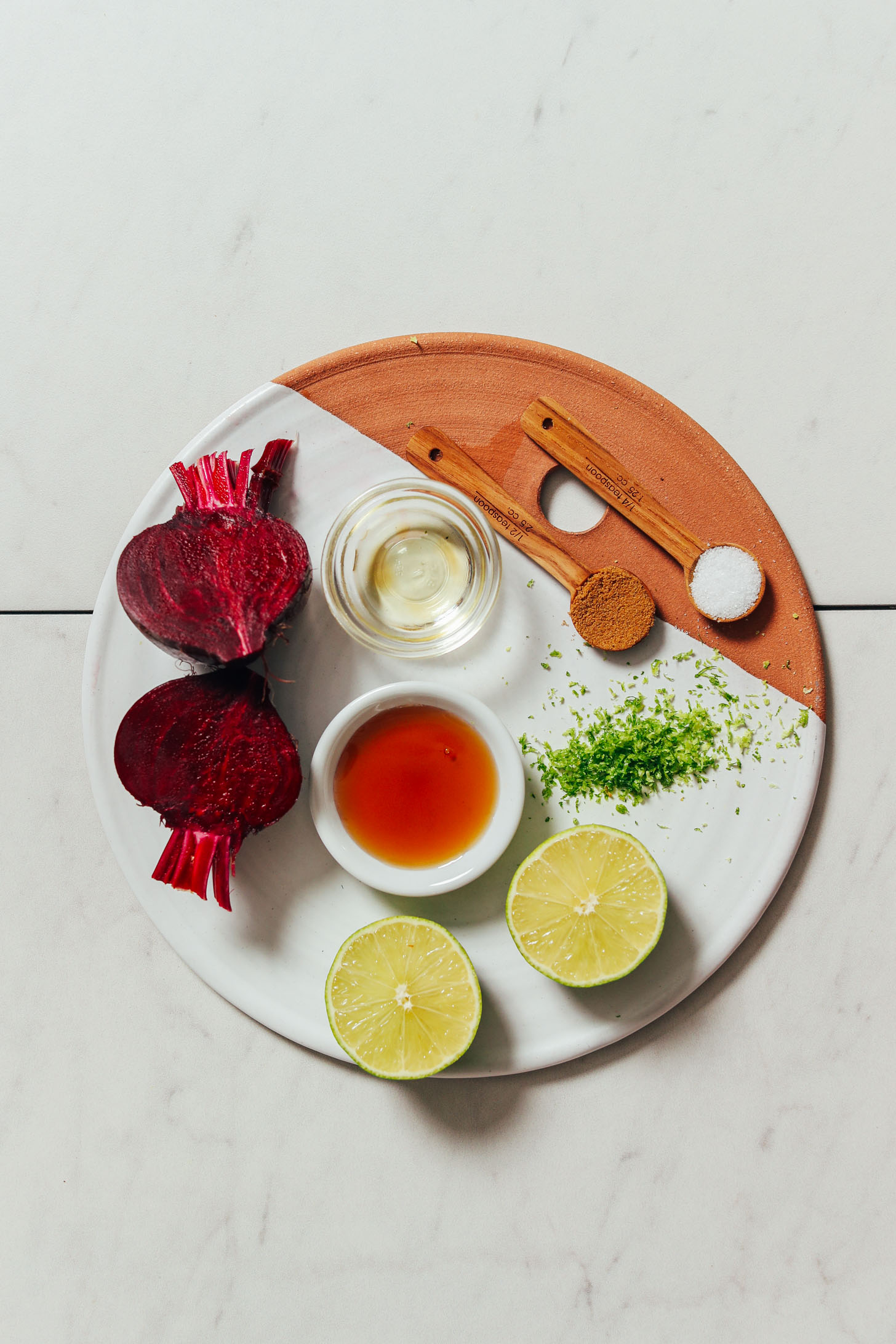 Beets, avocado oil, maple syrup, limes, lime zest, cumin, and sea salt on a tray