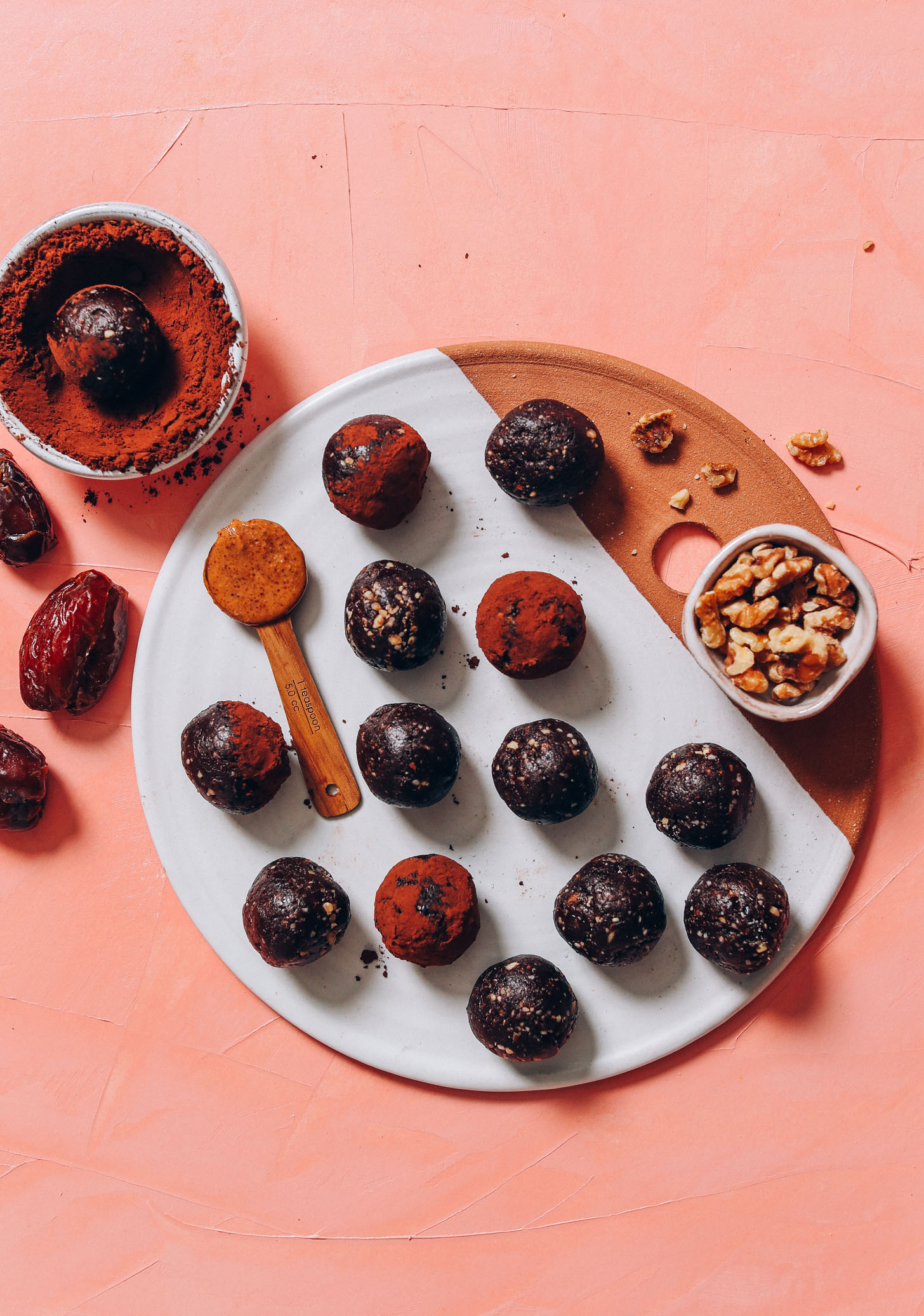 Dates, almond butter, cacao, and walnuts next to a tray of Vegan Brownie Bites