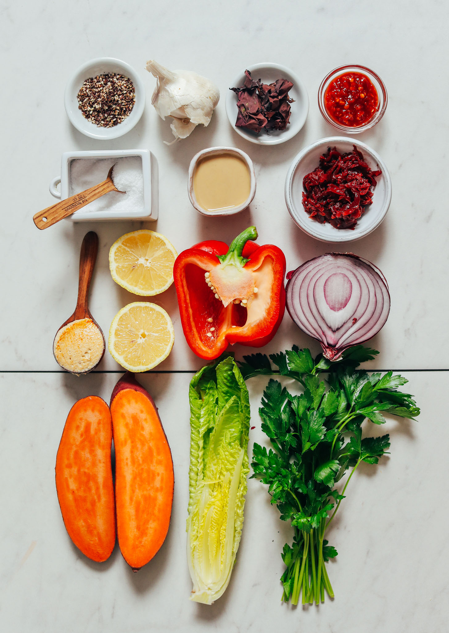 Parsley, romaine, sweet potato, red onion, bell pepper, lemon, hummus, sauerkraut, tahini, salt, za'atar, chili garlic sauce, dulse, and garlic