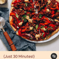 Slices of gluten-free vegan sausage pizza on a platter