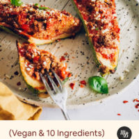 Vegan Zucchini Boats on a plate with fresh basil
