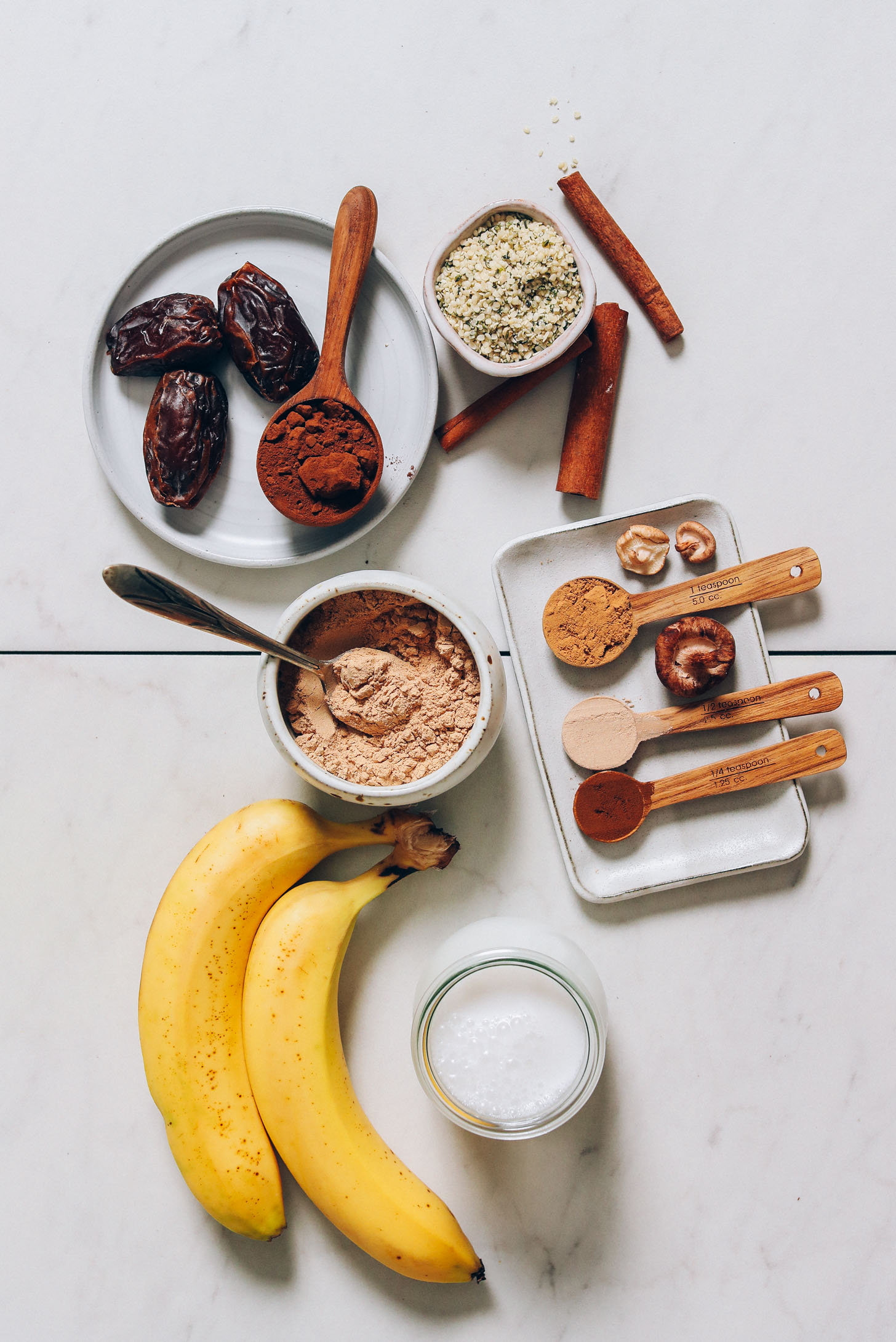 Dates, carob powder, maca, hemp seeds, cinnamon, reishi mushroom powder, maca, ashwagandha, he shou wu, coconut milk, and bananas