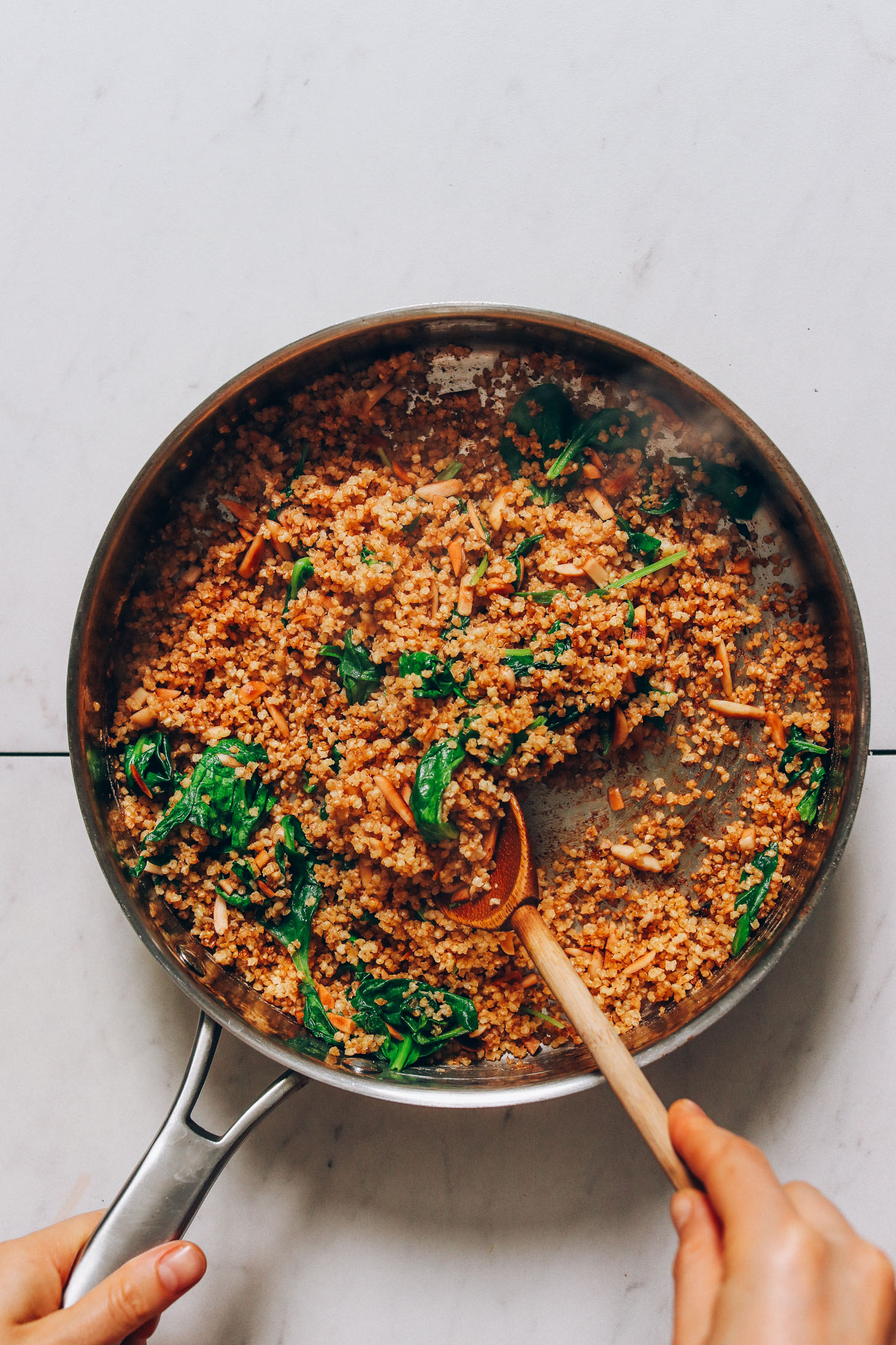 Sautéing millet and spinach with coconut aminos