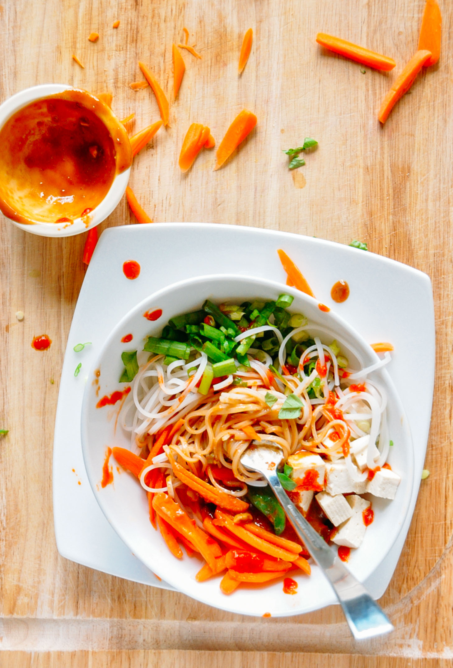 Overhead image of a veggie rice noodle bowl with ginger peanut dressing for minimalist baker
