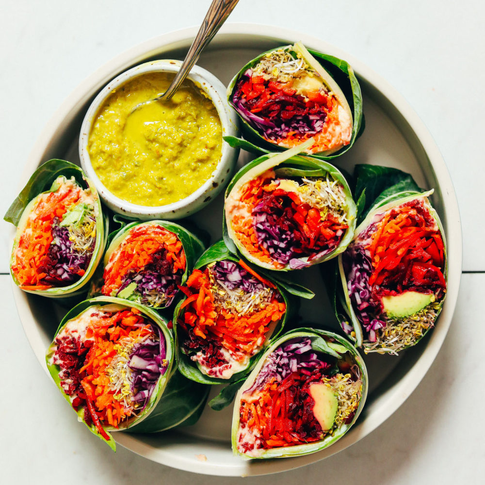 Veggie collard wraps with a bowl of Green Curry Tahini Sauce
