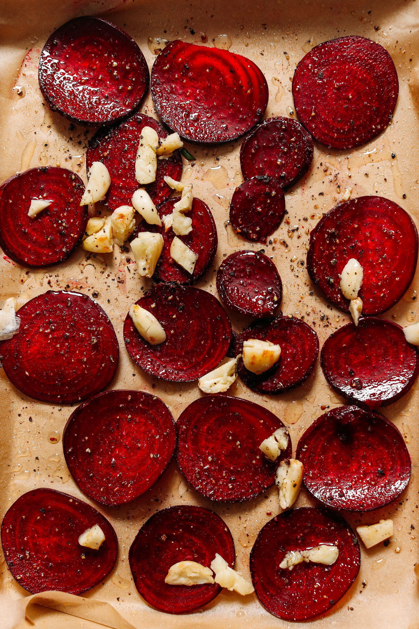 Baking sheet of sliced beets and garlic for roasting