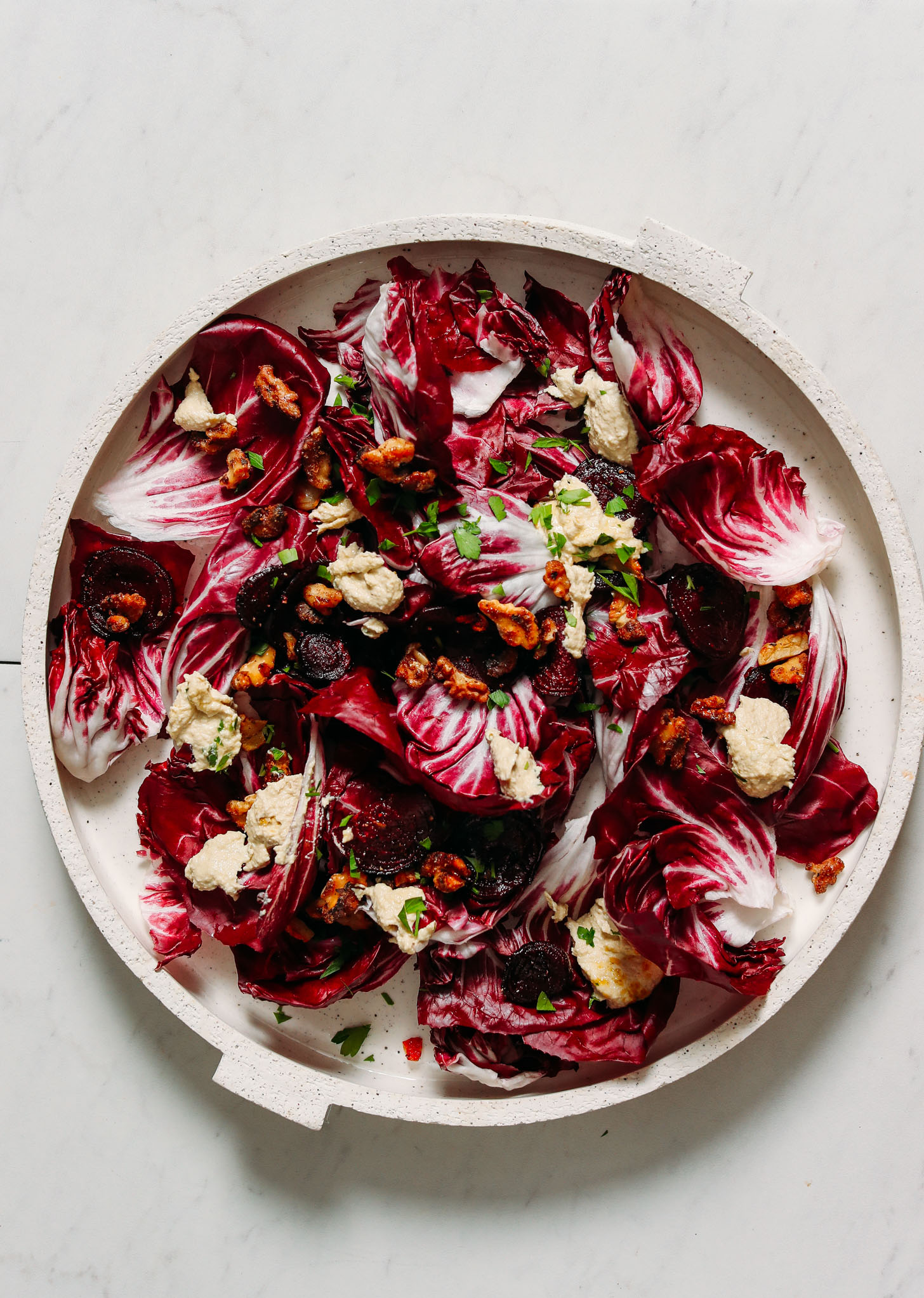 Platter of radicchio salad with roasted beets, garlic, and lemony cashew ricotta dressing