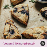 Parchment-lined baking sheet of Gluten Free Scones with Blueberries and Rosemary