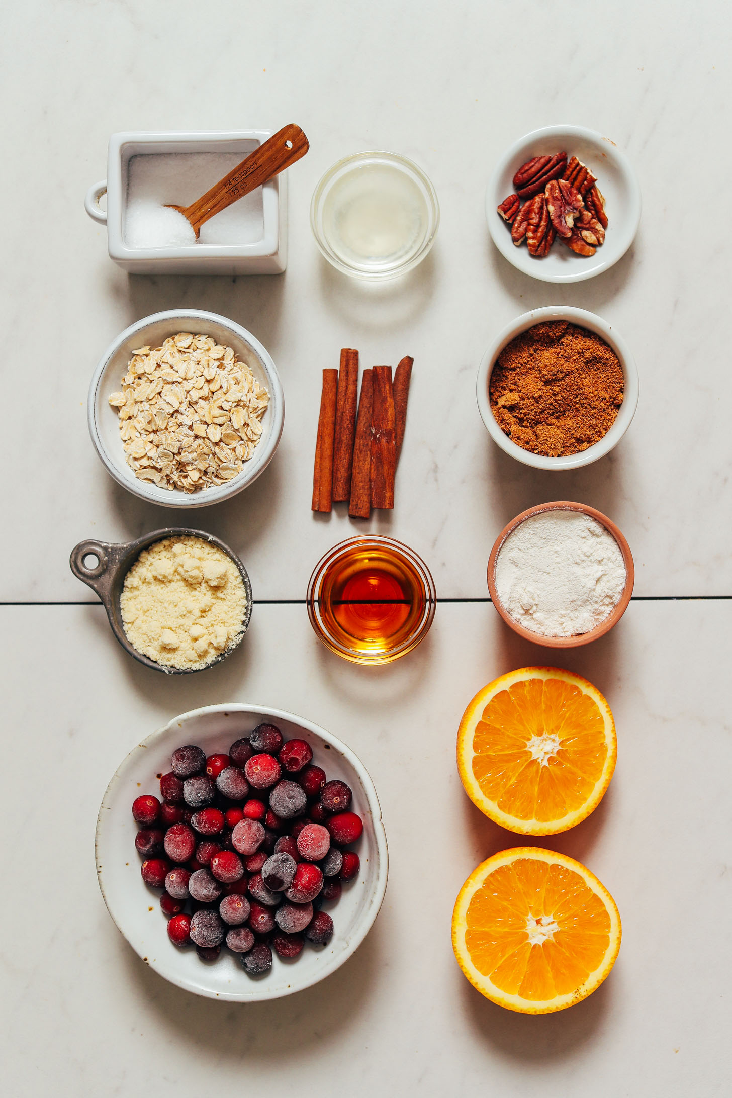 Oranges, cranberries, almond flour, maple syrup, gluten-free flour blend, oats, cinnamon sticks, coconut sugar, coconut oil, and sea salt
