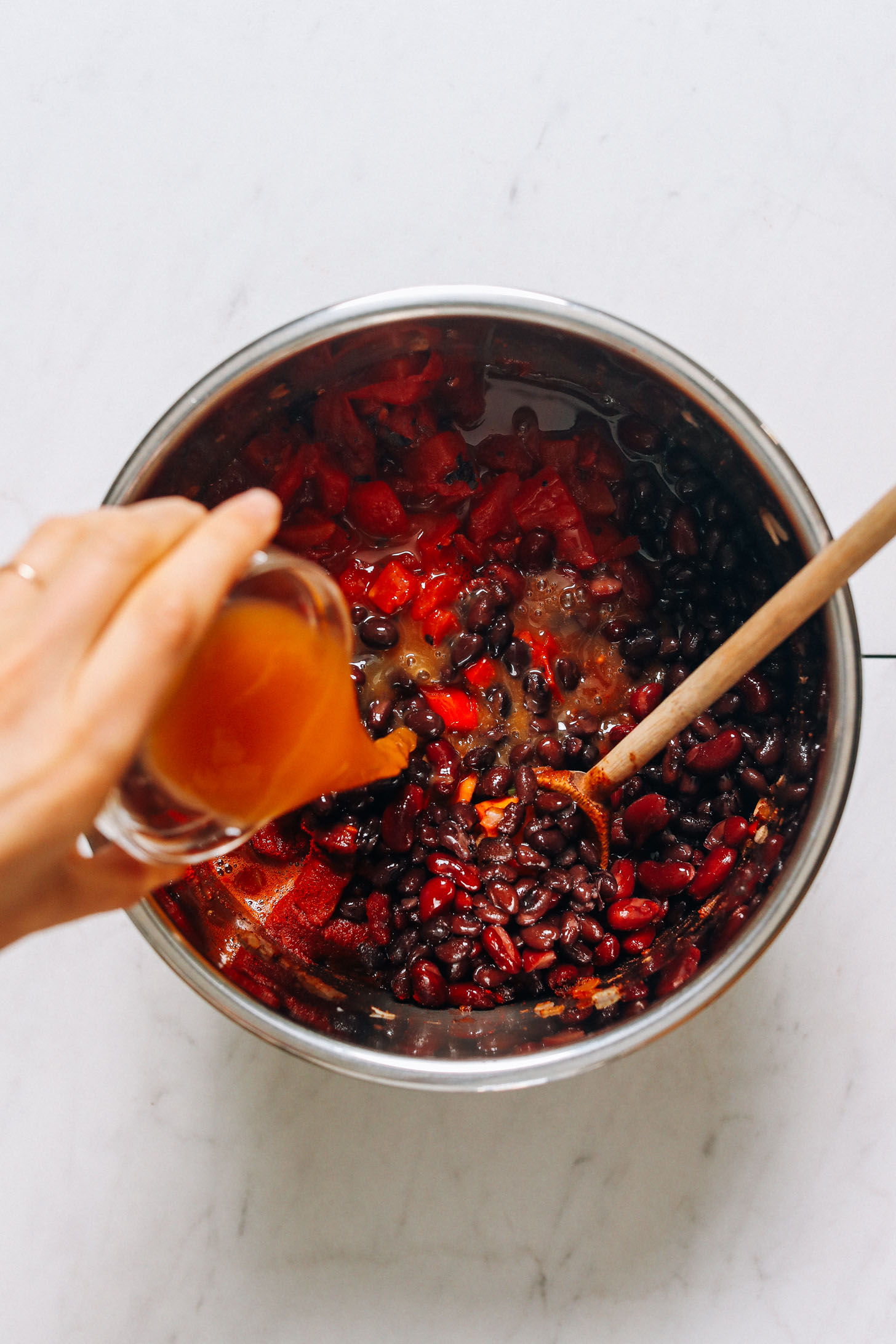 Pouring vegetable broth into an Instant Pot