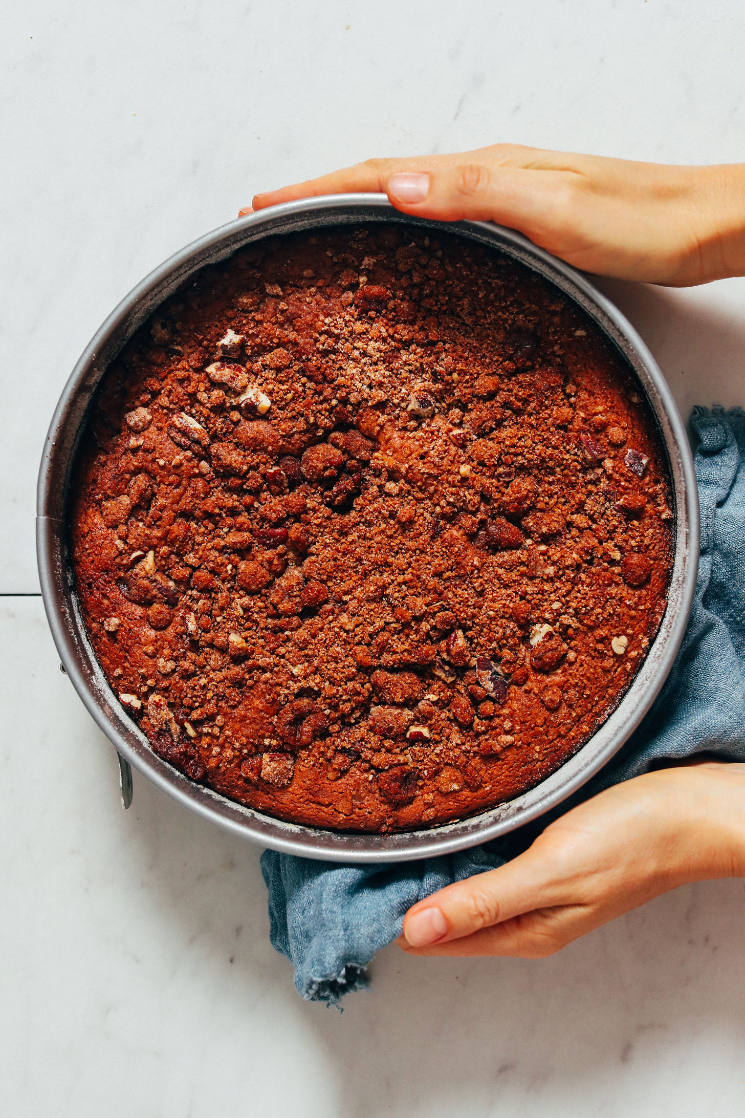 Holding a pan of vegan oil-free coffee cake