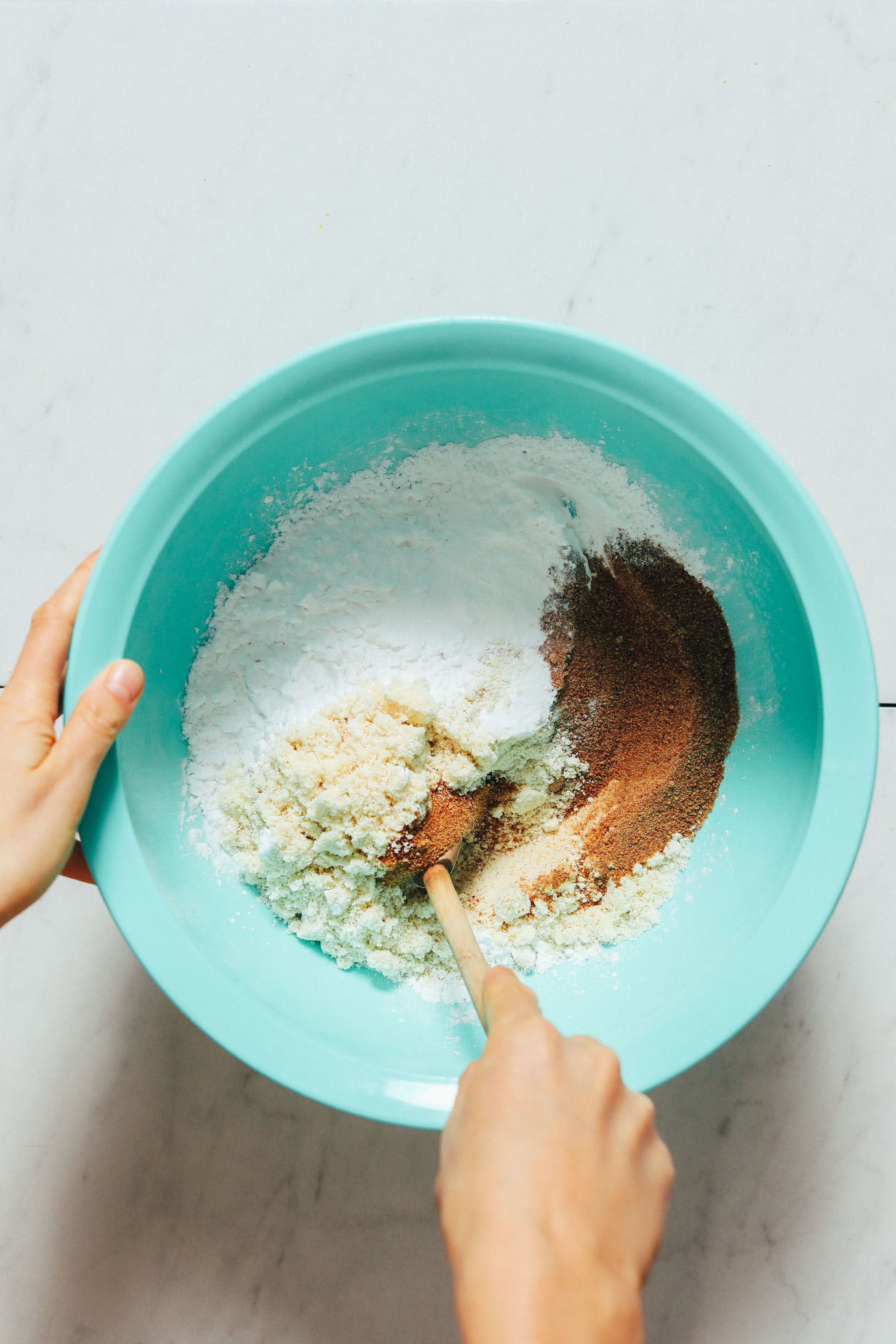 Stirring dry ingredients in a mixing bowl