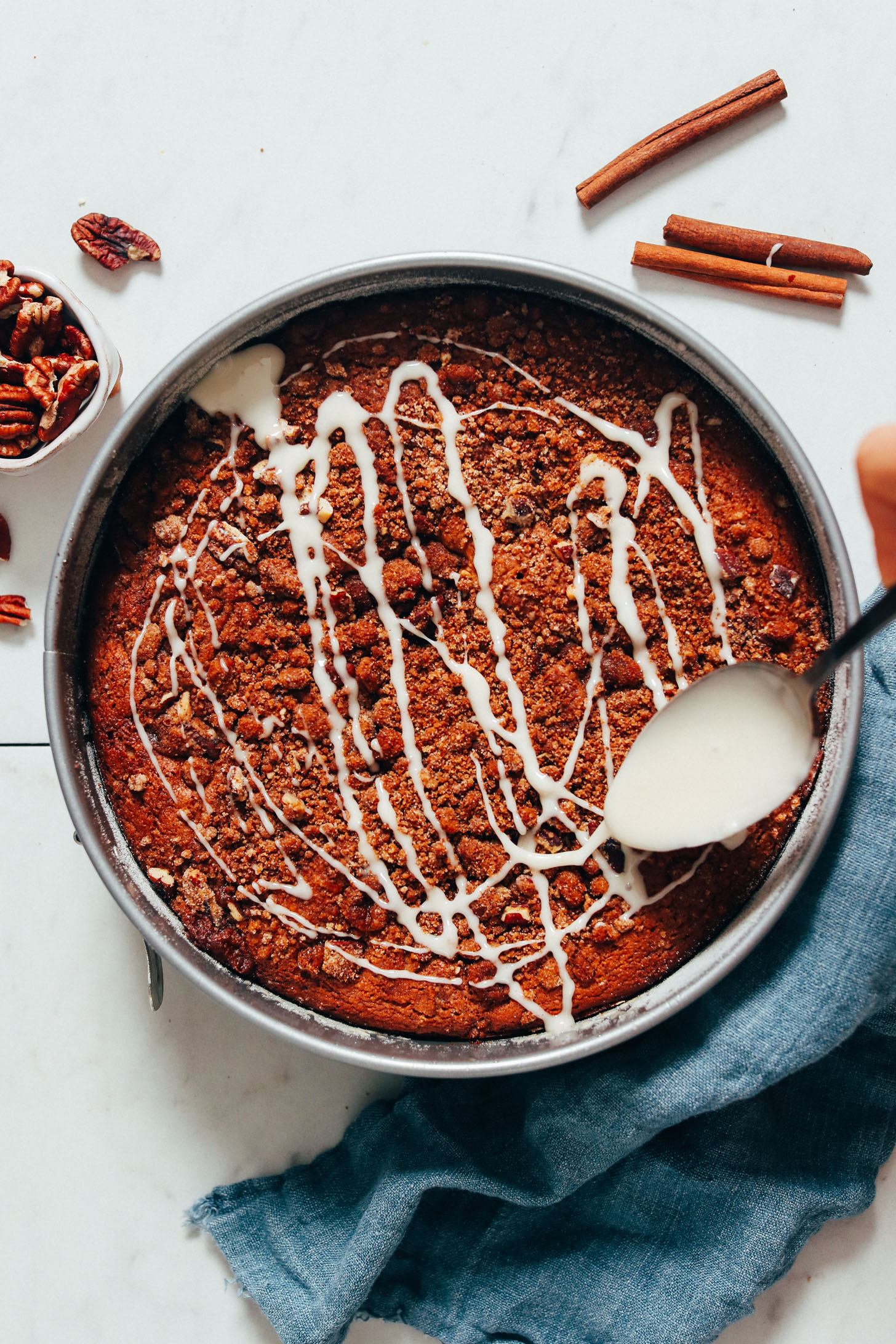 Drizzling glaze over vegan coffee cake