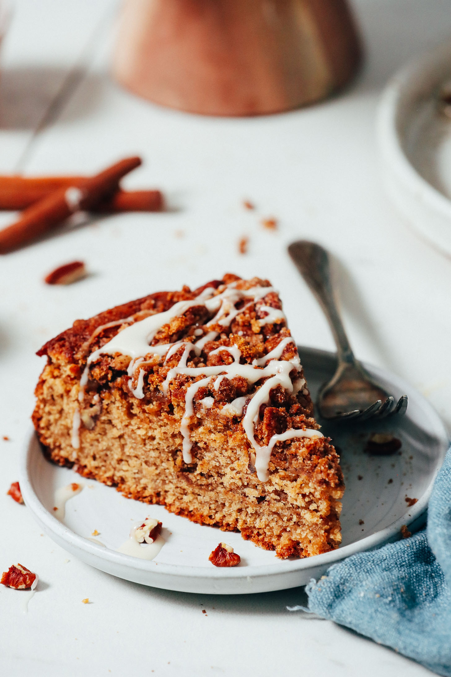 Slice of coffee cake drizzled with powdered sugar glaze