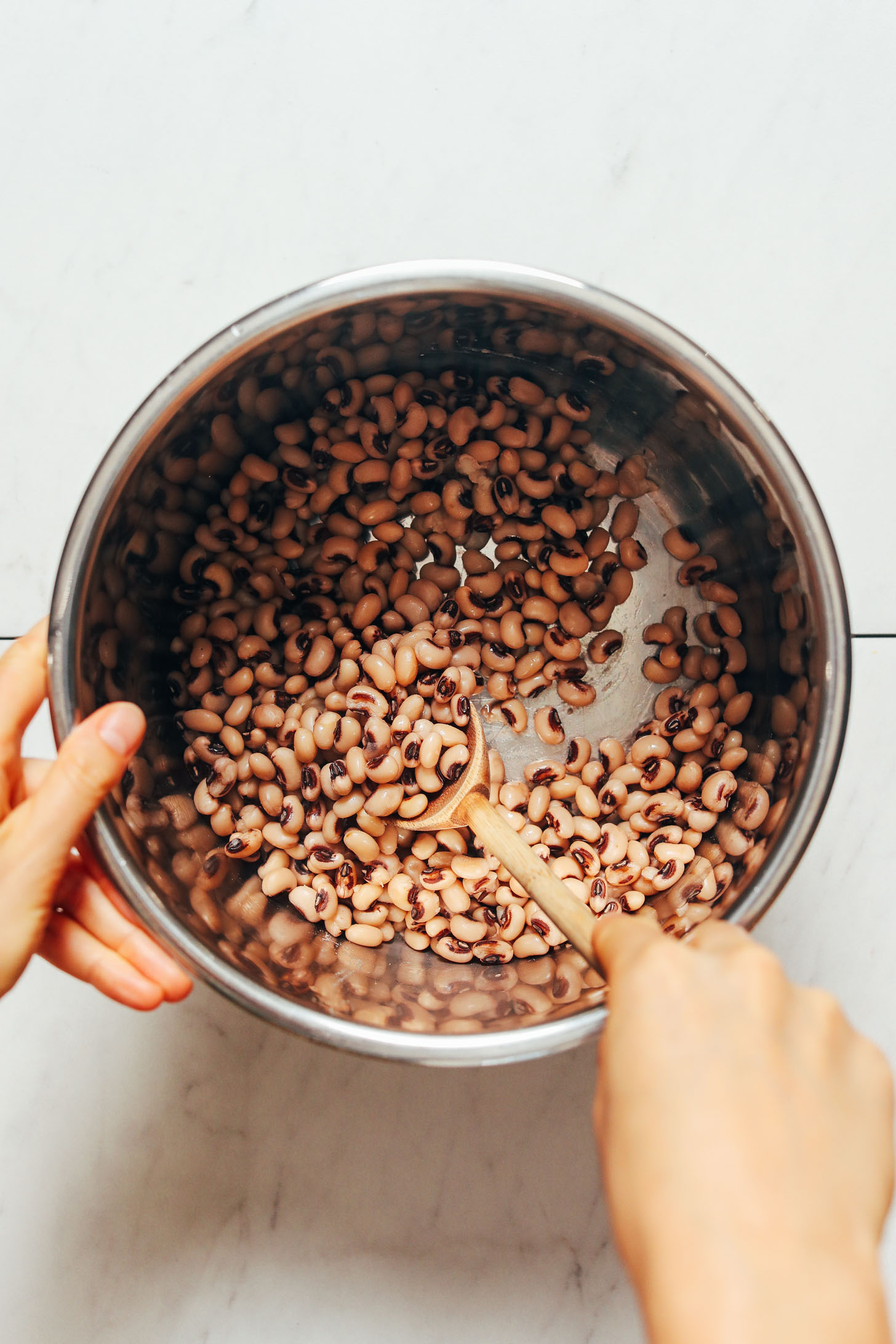 Stirring cooked black eyed peas in the Instant Pot