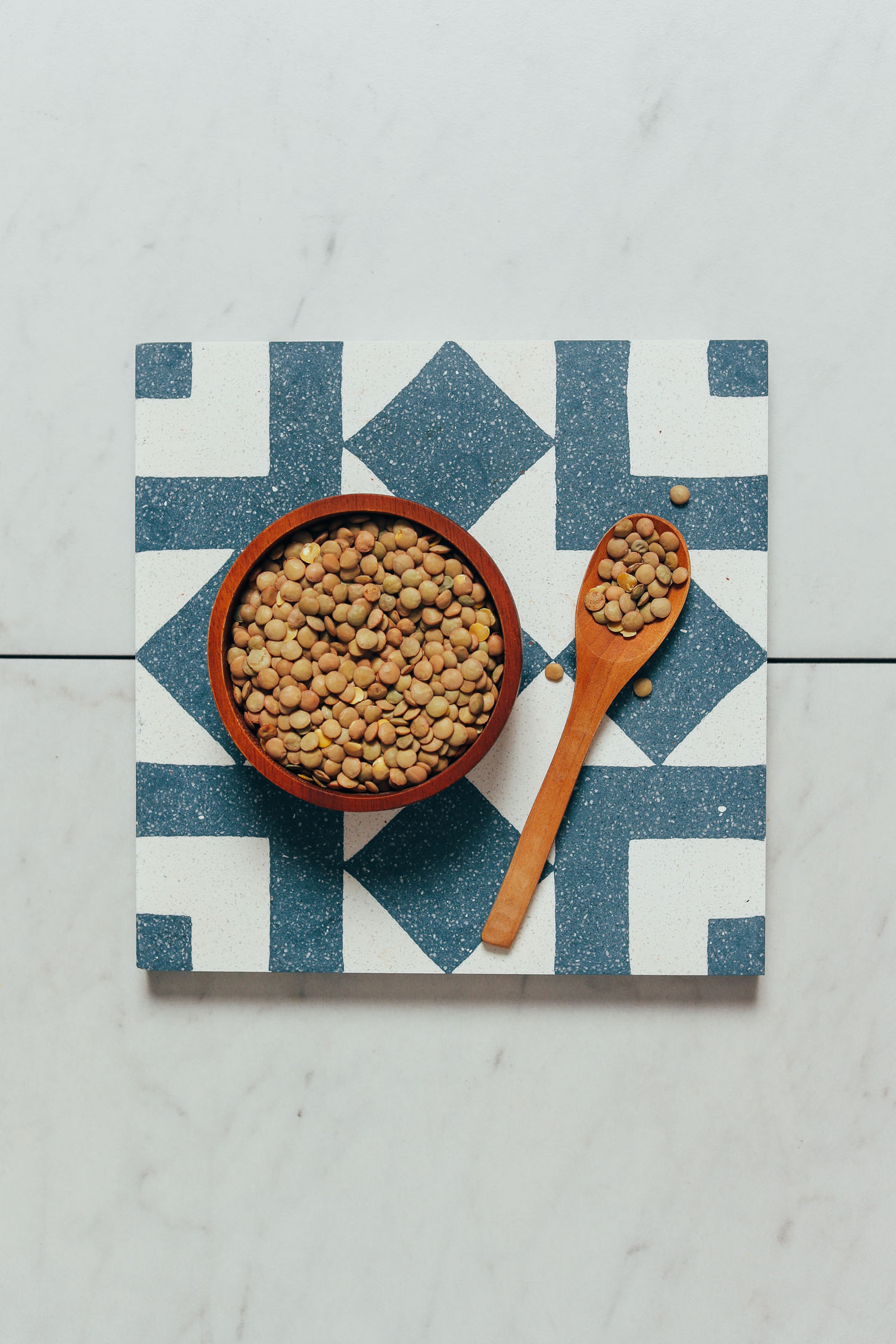 Spoonful and bowl of dried lentils