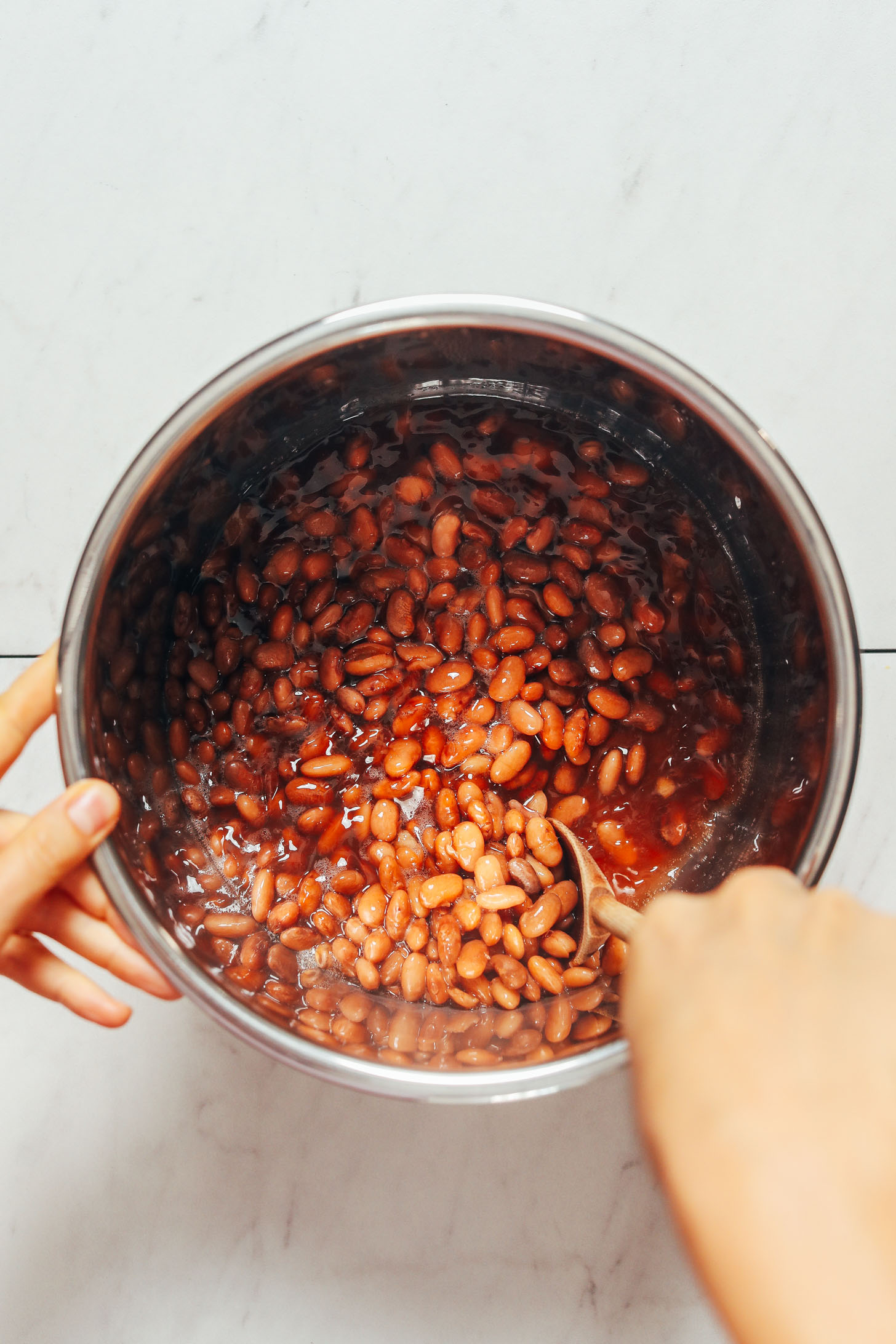 Stirring a pot of pinto beans