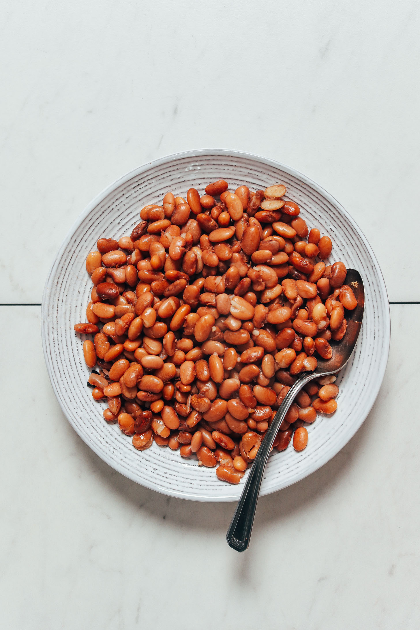 Vintage spoon in a bowl of Instant Pot pinto beans